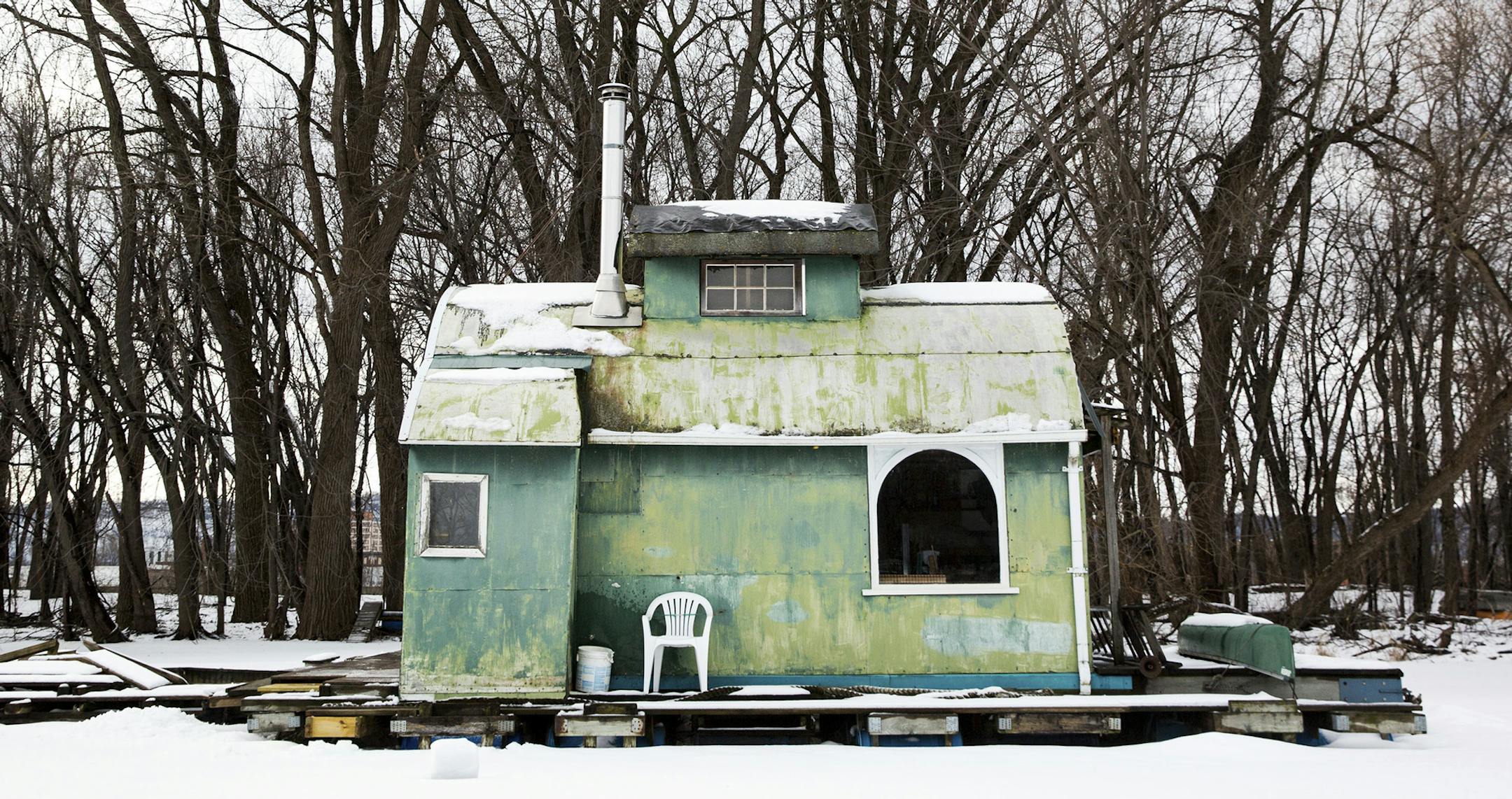 ADVANCE FOR SATURDAY FEB 25 AND THEREAFTER - In a Tuesday, Jan. 31, 2017 photo, one of more than 100 houseboats lining the shore of Latch Island sits frozen in place just outside of Winona, Minn. Life on the Mississippi is a joy, mostly, for the folks who live in Winona's funky houseboat community hugging the shore of Latsch Island in the middle of the Mississippi River. For decades, it's been home to roughly 100 tiny floating homes, although only a few residents stay through the winter. (Evan F