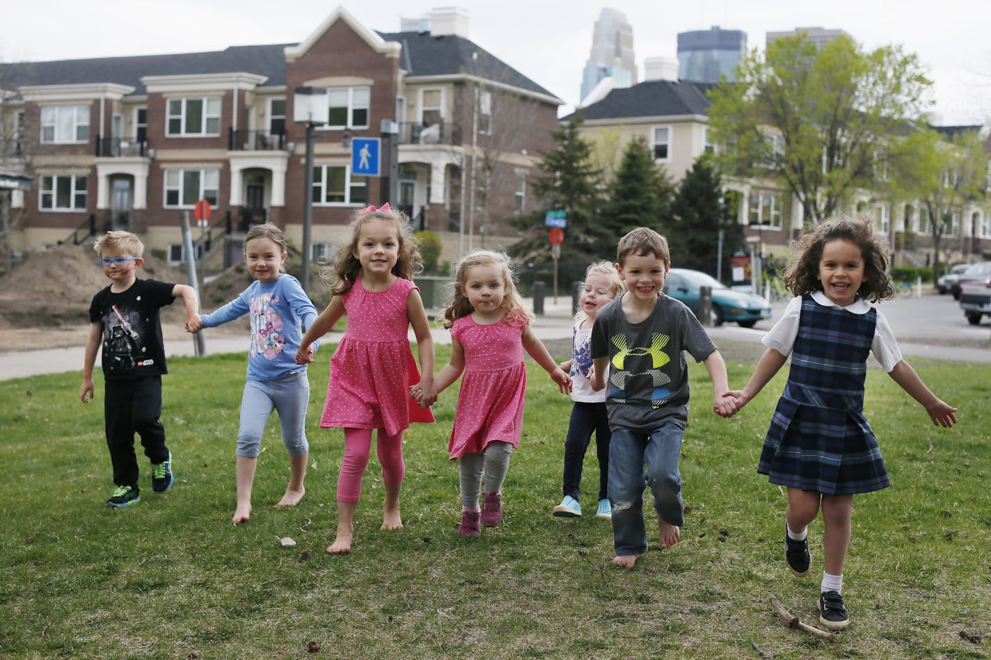 Children who live in the North Loop let to right Gus Auger, Sophia Helget, Allie Lima, Rachel Lima, Valerie Dusek, Nils Mullarkey, and Sabrine Bahi gathered at neighborhood to play Tuesday April 28, 2015 in Minneapolis, Minnesota. Downtown communities where neighbors live up and down not side by side.] Jerry Holt/ Jerry.Holt@Startribune.com