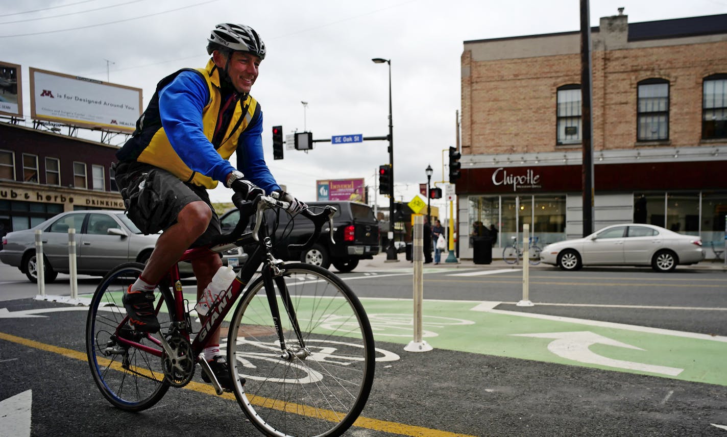 This curb-protected bike lane on SE Oak Street on the corner of Washington Av. in Minneapolis is intended to make bikers less nervous about riding through traffic.