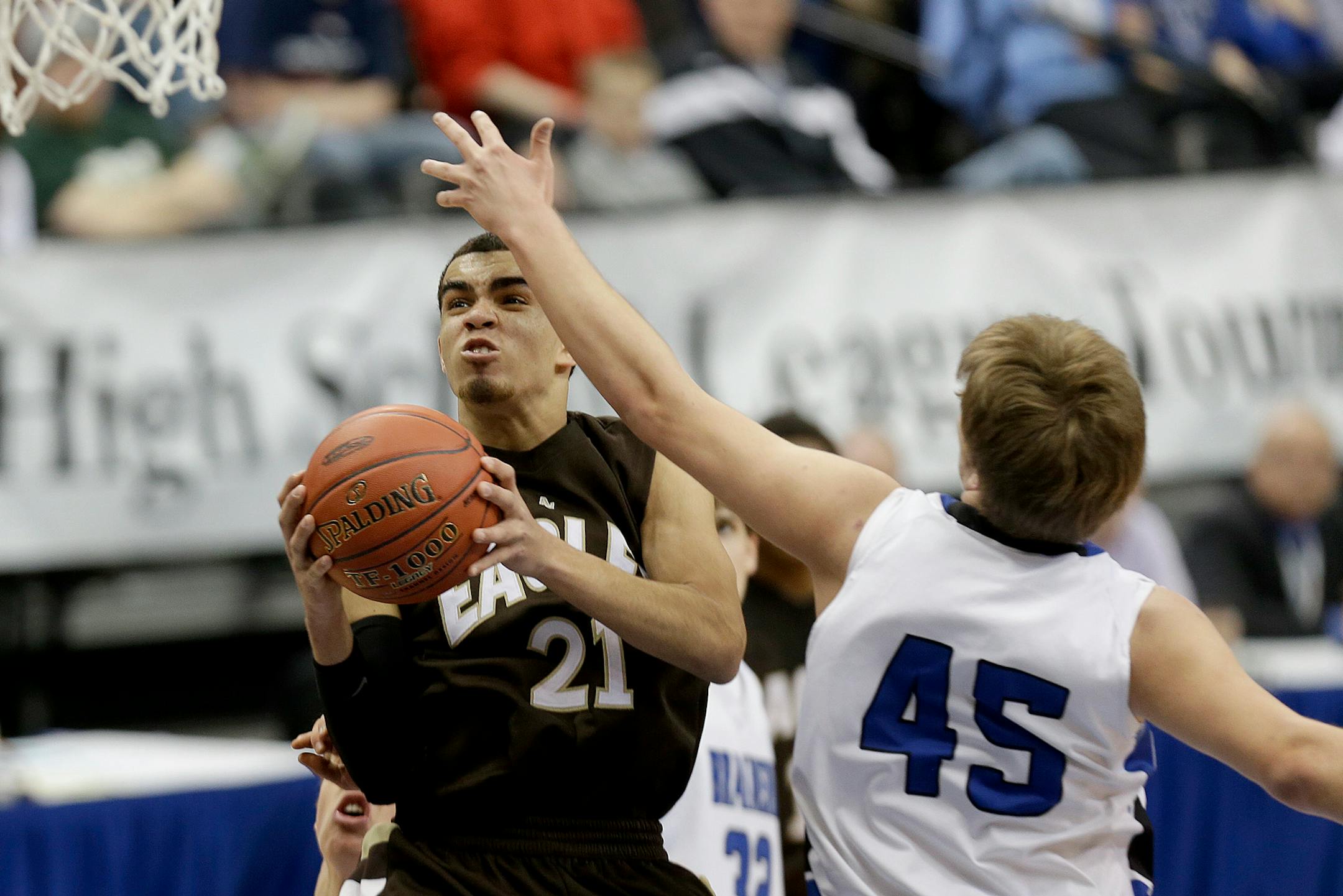 Apple Valley's Tyus Jones went up for two under pressure by Brainerd's Jagar Hanson