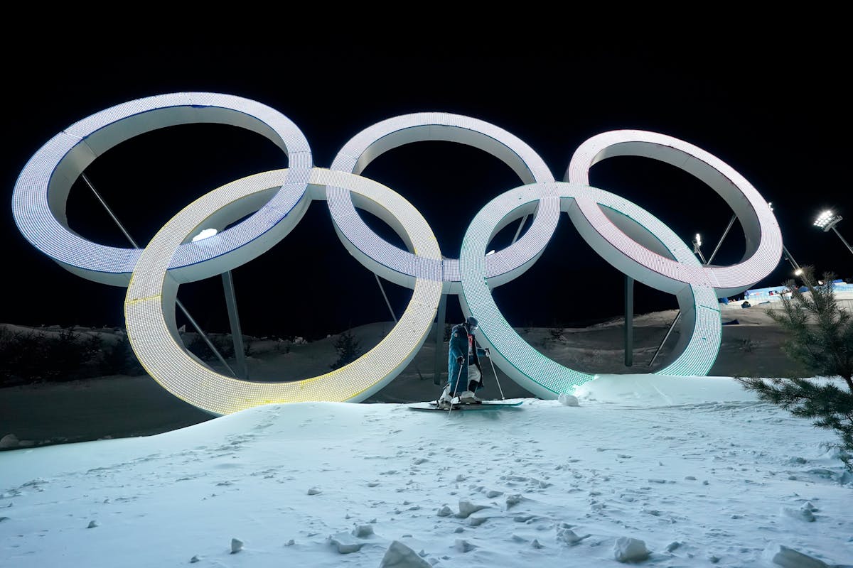 Switzerland’s Marco Tade takes pictures by the Olympic Rings during a training for the men’s freestyle moguls skiing competition .