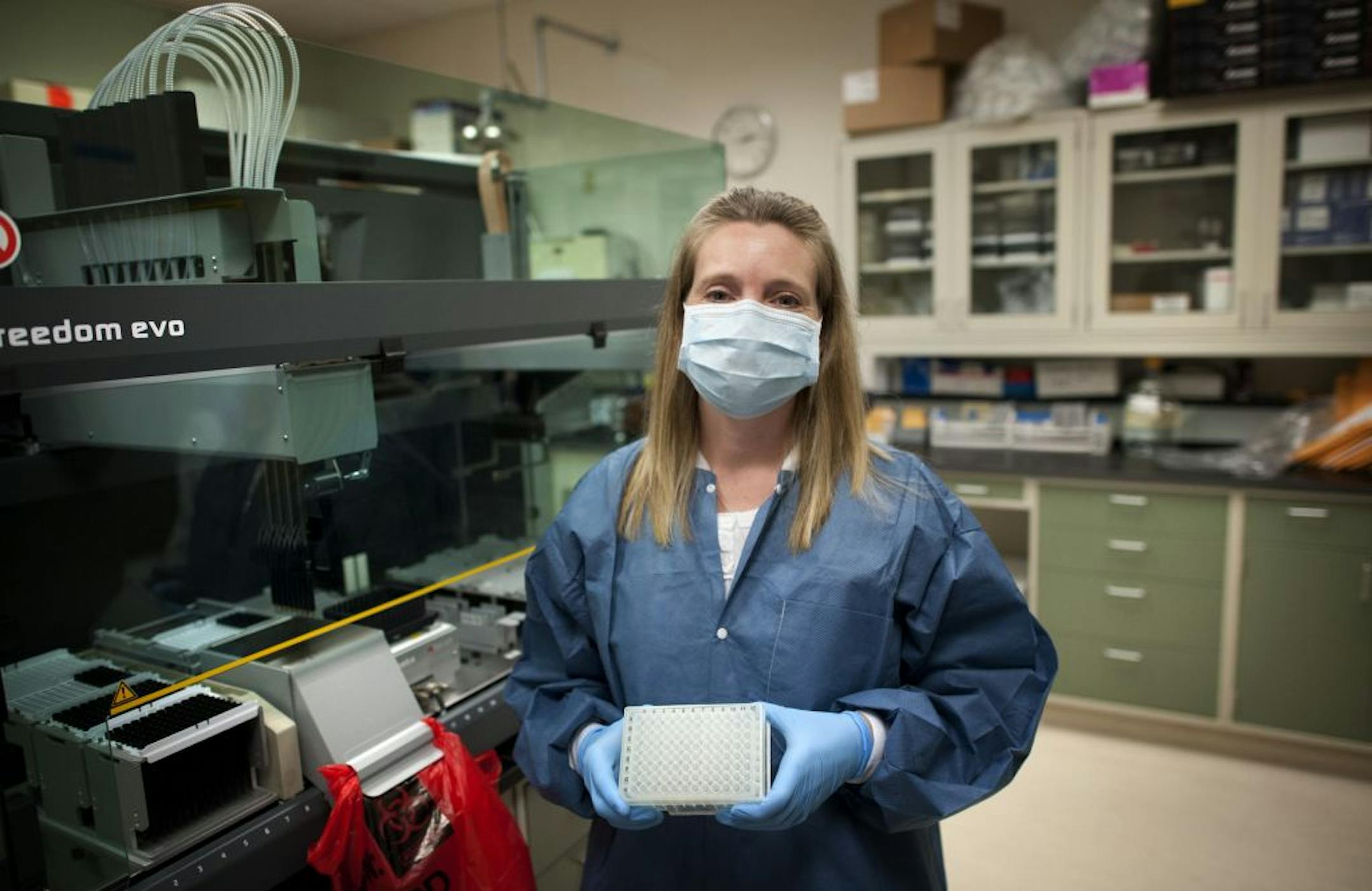 Bureau of Criminal Apprehension forensic scientist Beth Wolf with some if the equipment used to test 10,000 samples each year at the BCA DNA lab in St. Paul, Thursday, September 20, 2012