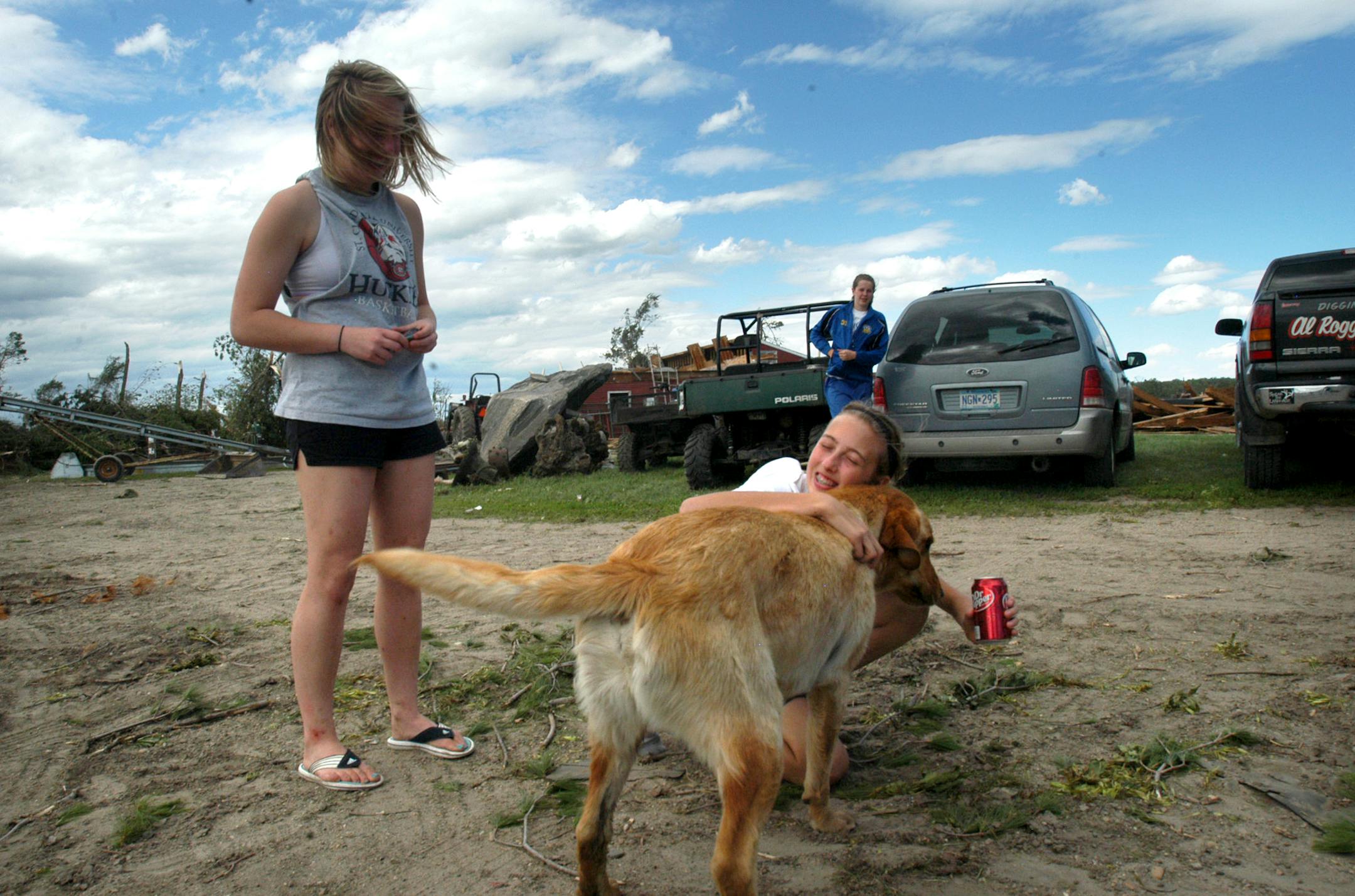 Caitlin Volkman, 15, was reunited with her dog, Buddy, who had disappeared Thursday night after a tornado had devasted the Sue and Tim Volkman's farm, west of Wadena.
