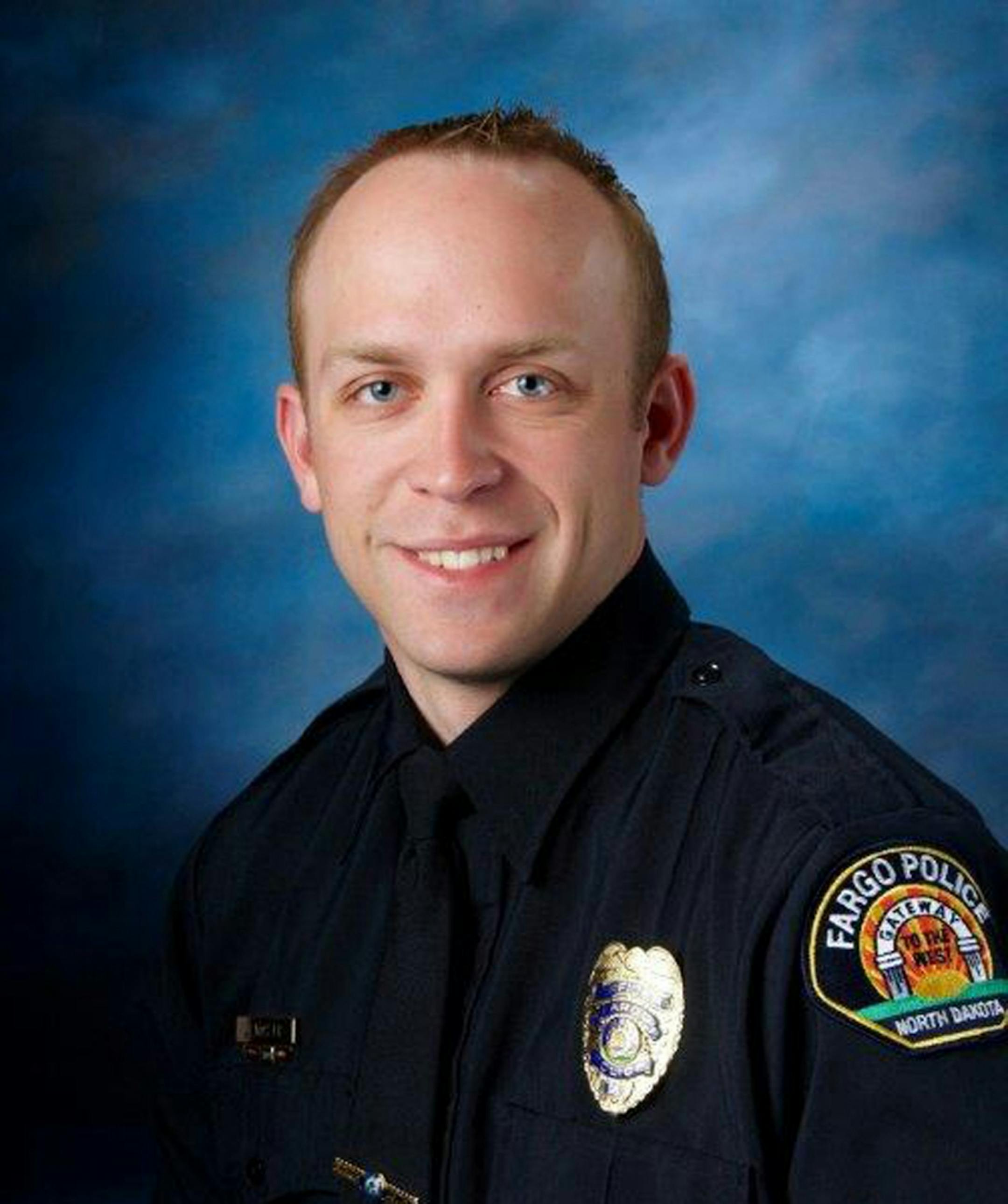 This undated photo released by Fargo Police Department shows Fargo police officer Jason Moszer. Moszer was shot amid a standoff in Fargo, N.D. with a domestic violence suspect, police in North Dakota said early Thursday, Feb. 10, 2016. Moszer, 33, responded to the standoff Wednesday night and parked near the home the suspect was barricaded inside, Fargo Deputy Police Chief Joe Anderson said. (Fargo Police Department via AP) MANDATORY CREDIT