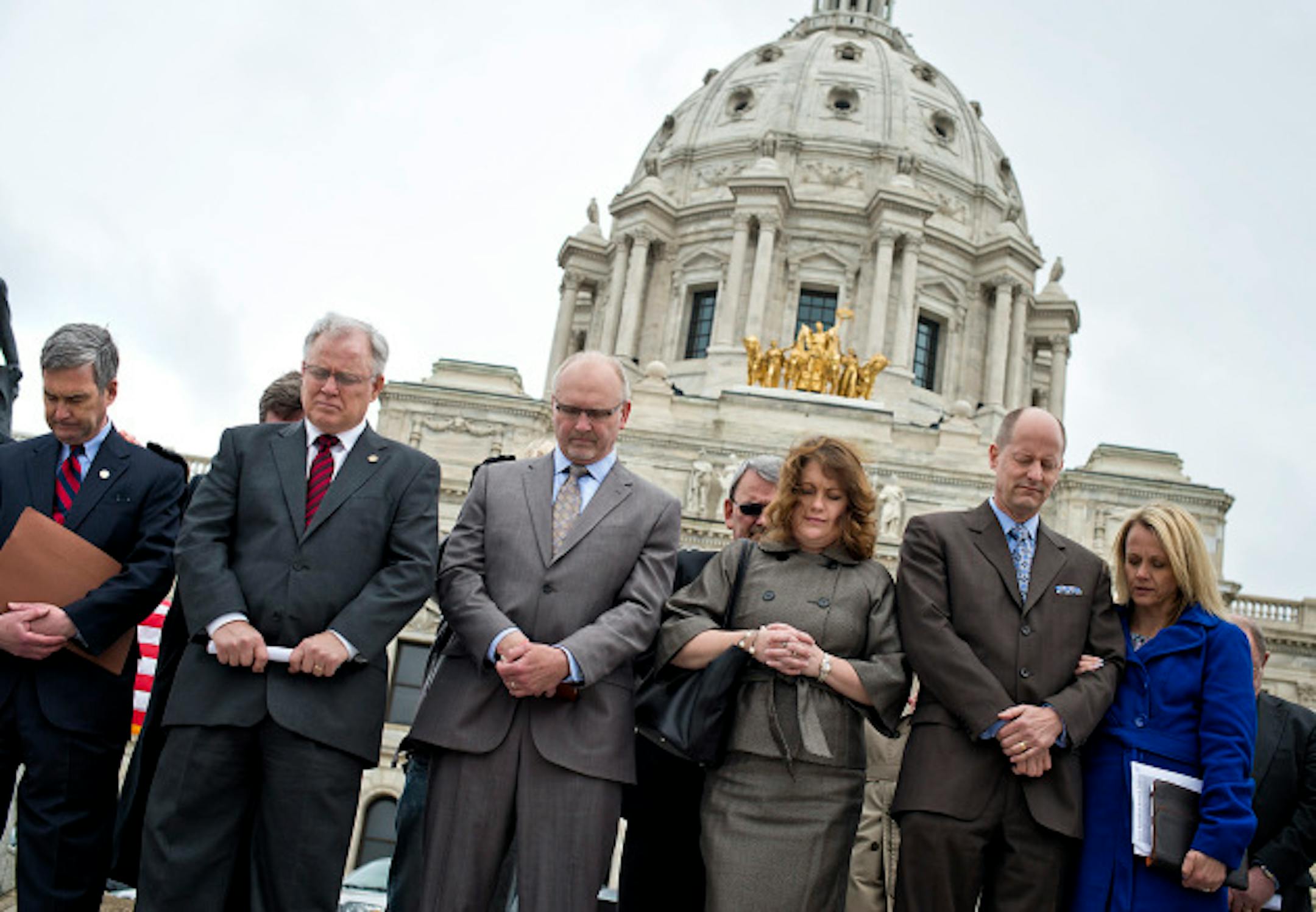 Members of the Minnesota State Senate, David Hann, Dan Hall, Roger Chamberlain, Michelle Benson Paul Gazelka and wife Maralee Gazelka, bowed their heads in prayer in front of the Capitol during the National Day of Prayer.    At the same time Minnesota Atheists held their Day of Reason inside the Capitol Rotunda, the National Day of Prayer was being celebrated outside the Capitol.  Thursday, May 2, 2013     ]   GLEN STUBBE * gstubbe@startribune.com