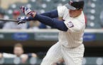 Minnesota Twins' Max Kepler follows through with an RBI single off Colorado Rockies pitcher Tyler Chatwood during the first inning of the second game 