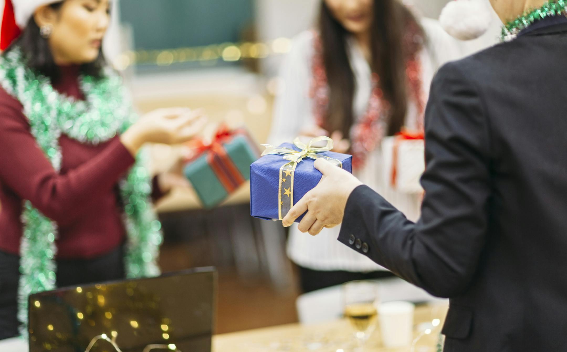 Businesswomen are exchanging Christmas presents in office. istock photo ORG XMIT: 775032757