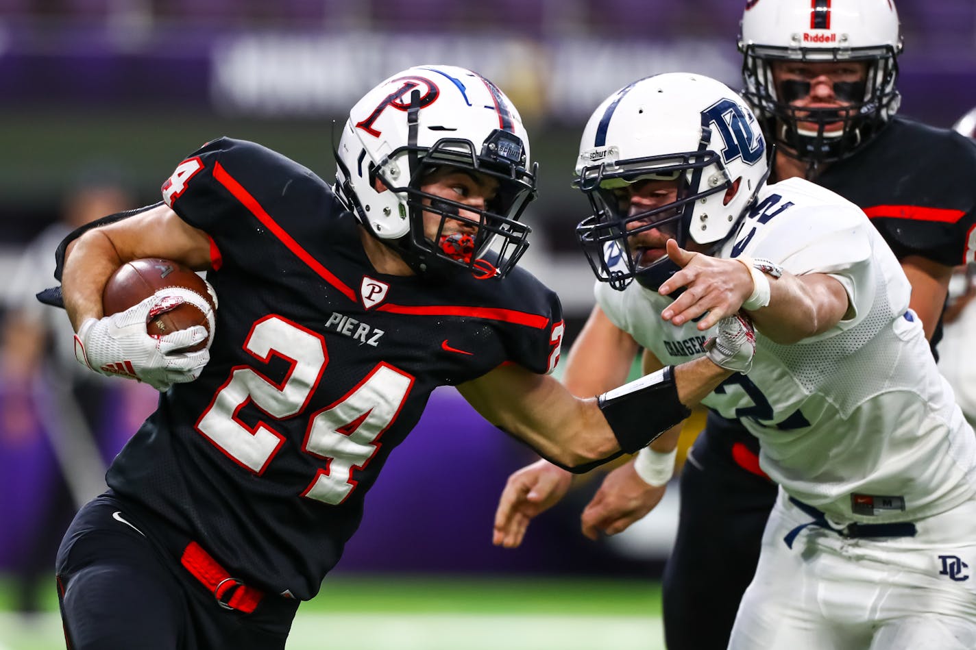 Pierz Pioneers running back Matthias Algarin (24) runs with the ball against Dassel-Cokato Chargers defensive lineman Teddy Bergquist (52) in the second quarter.