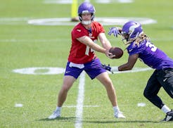Vikings quarterback Sam Darnold hands off to running back Aaron Jones during a drill at this week's mandatory minicamp.