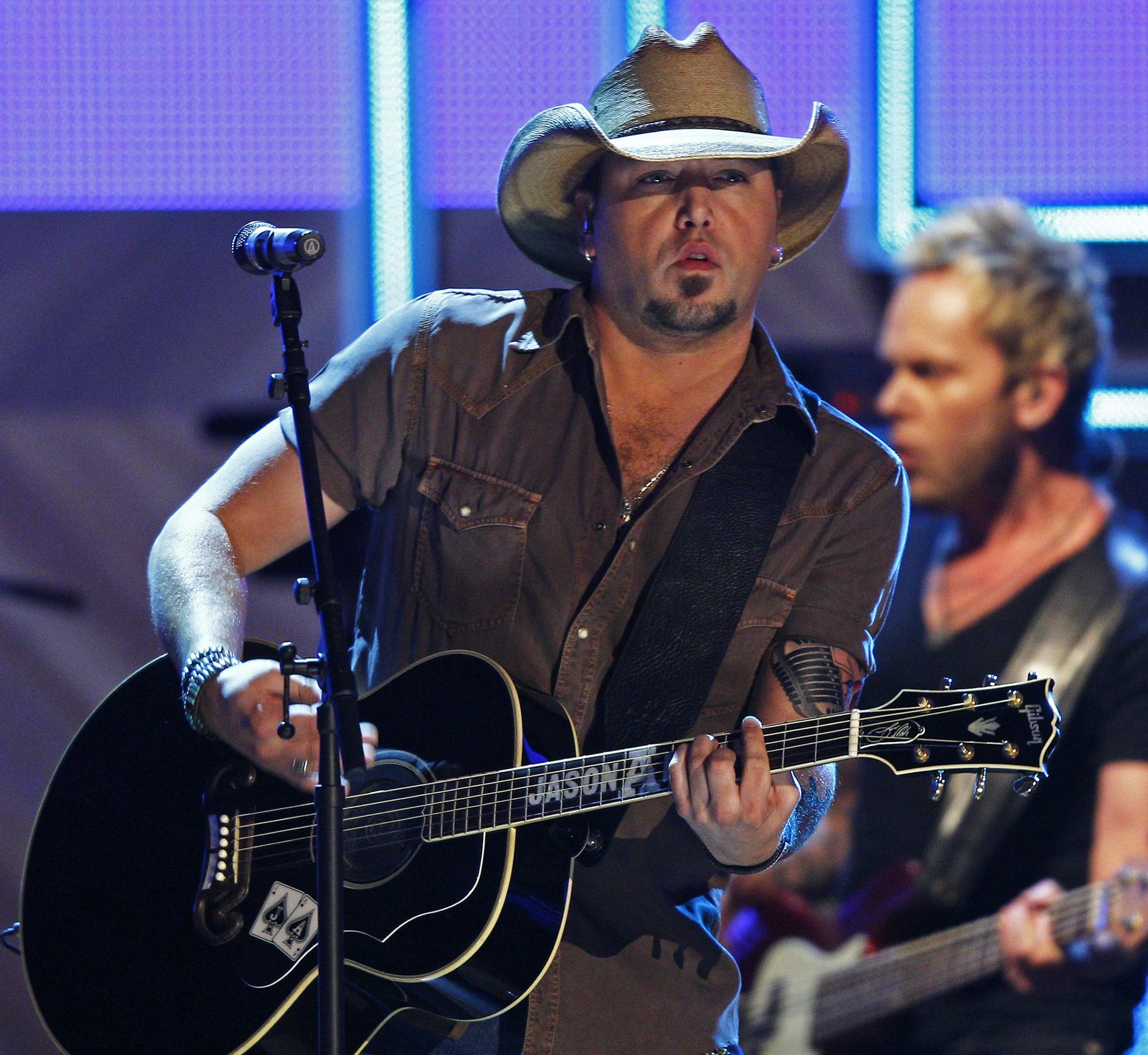 Jason Aldean performs during the CMT Artist of the Year Awards at the Schermerhorn Symphony Center on Tuesday, Dec. 2, 2014, in Nashville, Tenn. (Photo by Wade Payne/Invision/AP) ORG XMIT: TNWP119