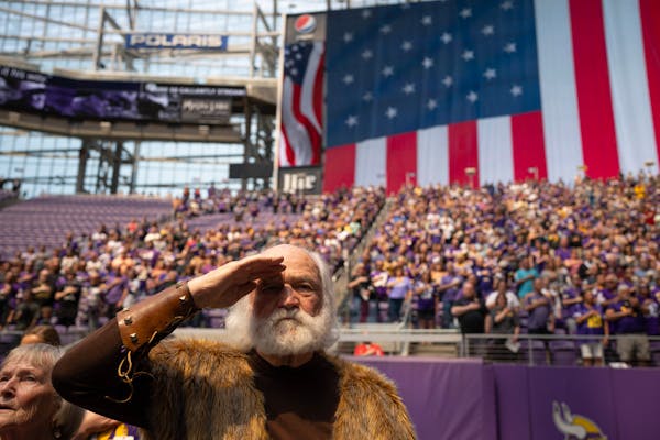 Hub Meeds, the original Vikings mascot, saluted during the singing of the national anthem at the beginning of the program.