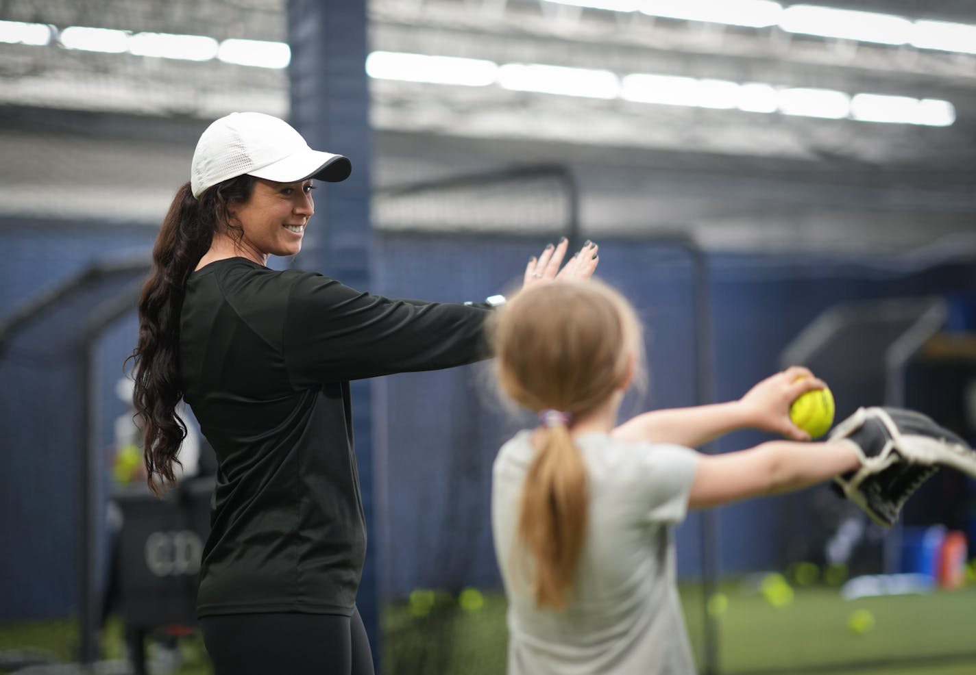 Sara Moulton, co-owner of Strike Zone Sports works with Josie Bjergo, 9, on some softball pitching drills Friday, May 5, 2023 Eagan, Minn. ] GLEN STUBBE • glen.stubbe@startribune.com