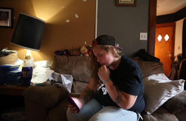 Katelynn Lahman looks at some selfies she took inside her parents house during an interview with a Tribune reporter on Oct. 23, 2105 in Dixon, Ill. Sh