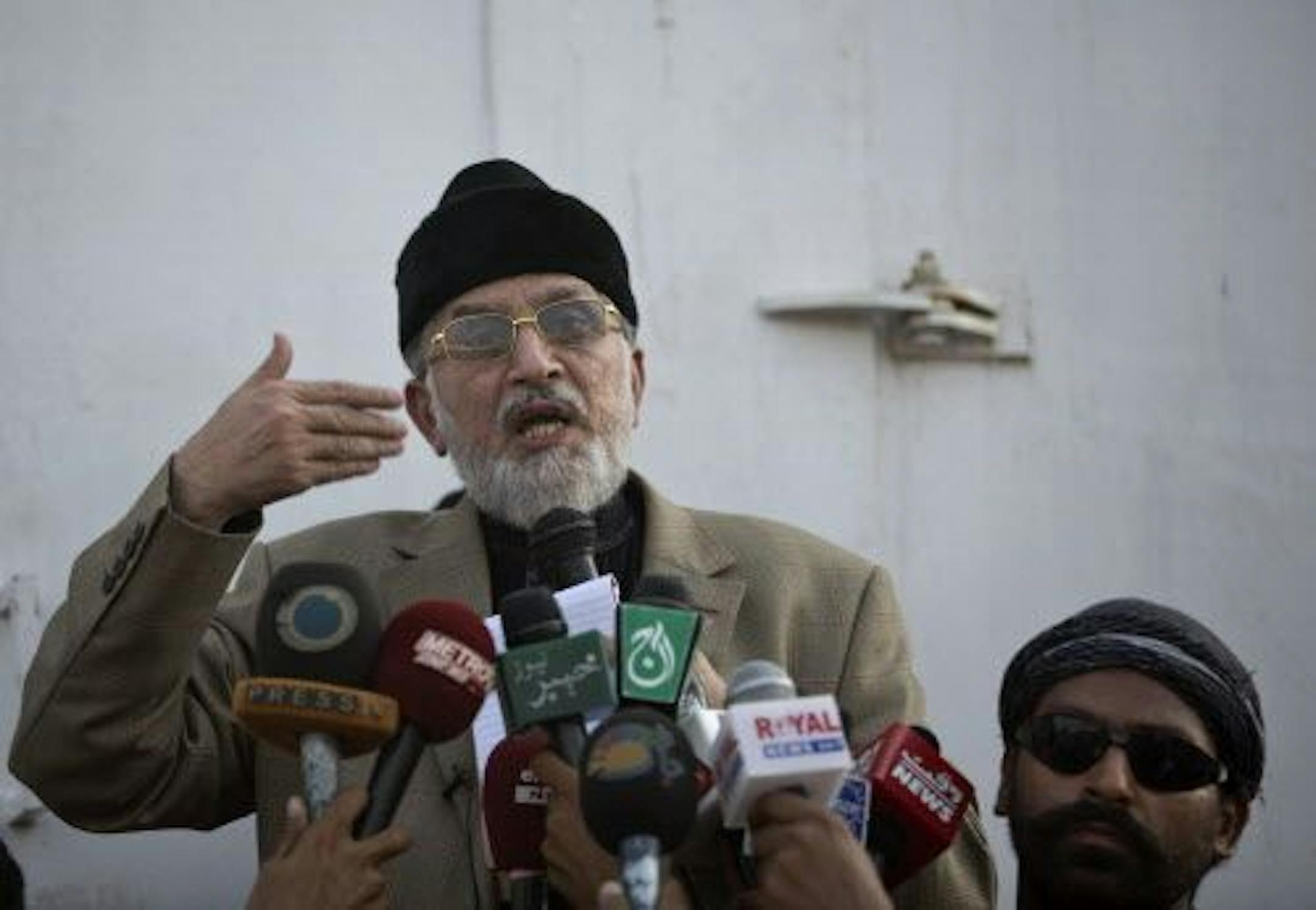 Anti-government cleric Tahir-ul-Qadri, gestures while delivering a speech to his supporters, during a protest in front of the Parliament building in Islamabad, Pakistan, Wednesday, Aug. 20, 2014.