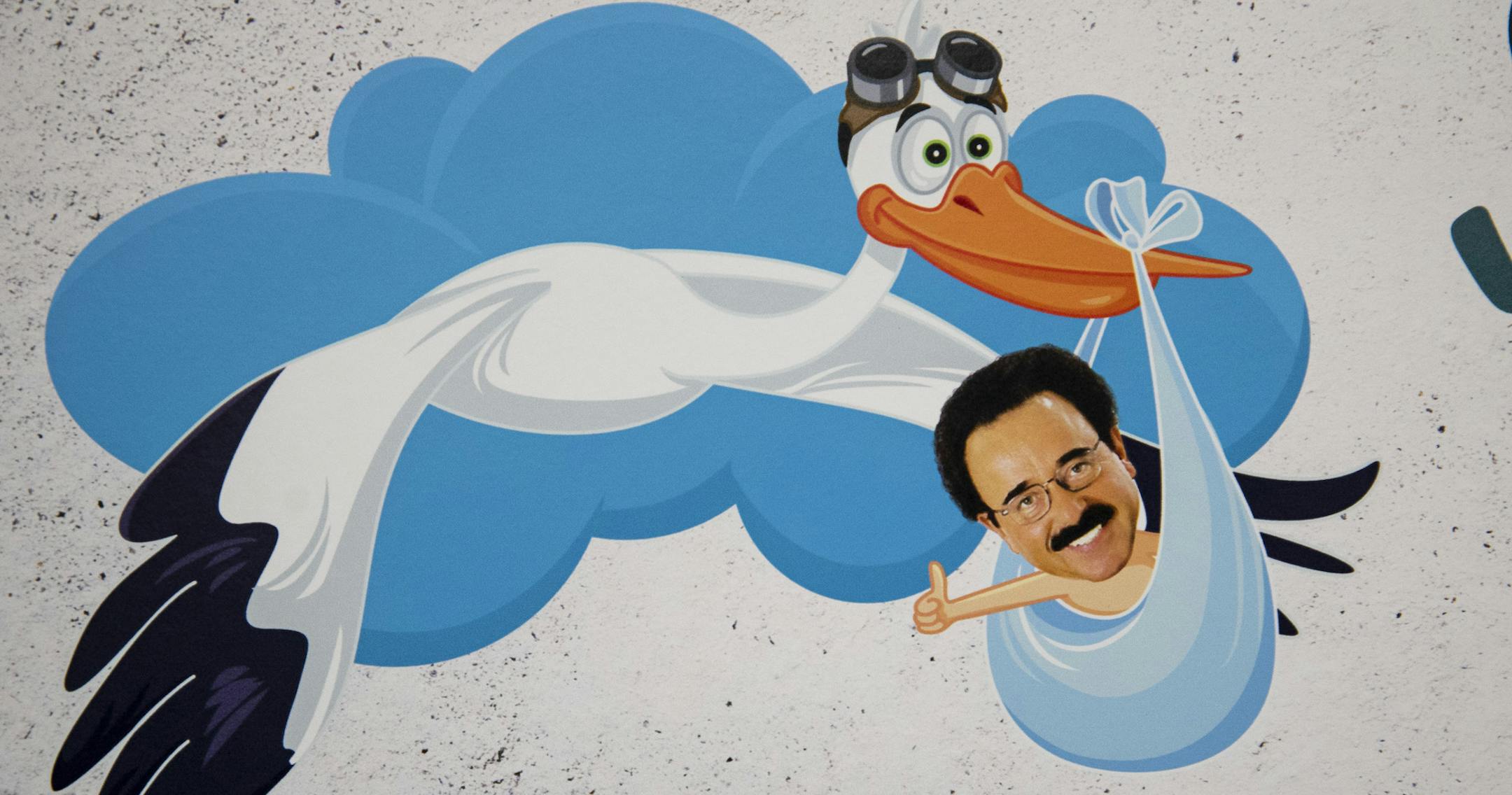 A photo of Dick Enrico in a stork's blanket is on a sign in the front of the store. Enrico has his face plastered on many forms of marketing materials including signs, posters and bobbleheads.