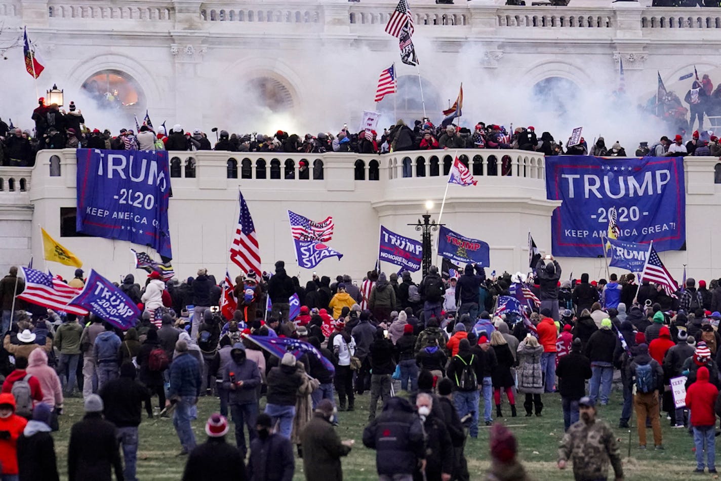 FILE - In this Jan. 6, 2021 file photo rioters supporting President Donald Trump storm the Capitol in Washington. An Army reservist charged with taking part in the attack on the U.S. Capitol was known as a Nazi sympathizer who wore a Hitler mustache, coworkers told federal investigators. Timothy Hale-Cusanelli, 30, was employed as a security contractor at a Navy base when he was alleged to have breached the Capitol on Jan. 6, authorities said. In court papers filed Friday, federal prosecutors in Washington said his coworkers at the Naval Weapons Station Earle in Colts Neck, New Jersey, told investigators that he held white supremacist views. (AP Photo/John Minchillo, File)