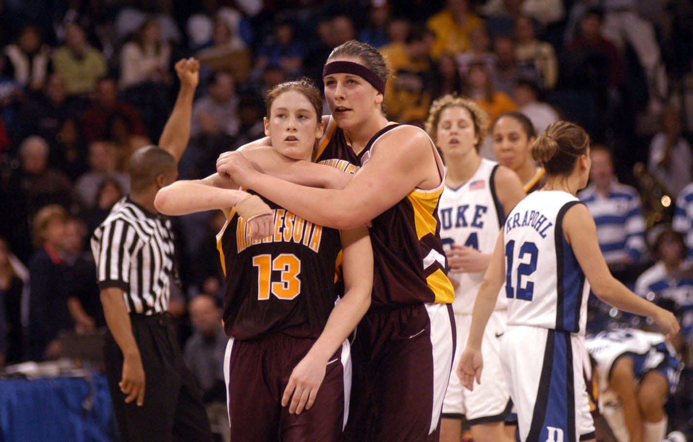 KYNDELL HARKNESS/Star Tribune, Tuesday March 30, 2004, Norfolk, Virginia -- Minnesota Gophers vs Duke in the NCAA women's tournament. Minnesota wins to advance to the Final Four. -- Janel McCarville hugs Lindsay Whalen #13 as she walks her to the foul line with seconds left in the game.