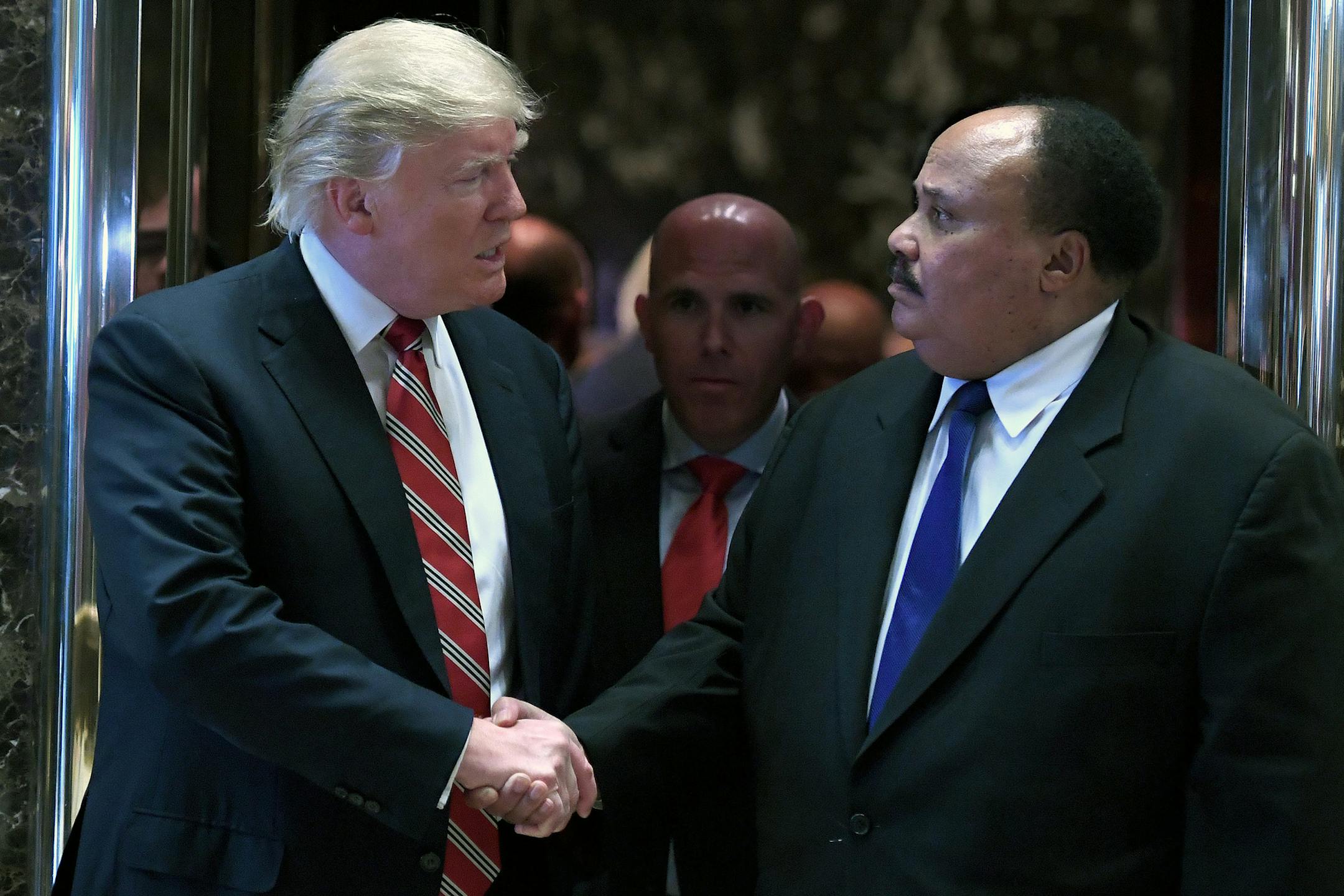 President-Elect Donald J. Trump, left, shakes hands with Martin Luther King III as they exit the elevators in the lobby of the Trump Tower Monday, Jan. 16, 2017 in New York. (Anthony Behar/Sipa USA/TNS)