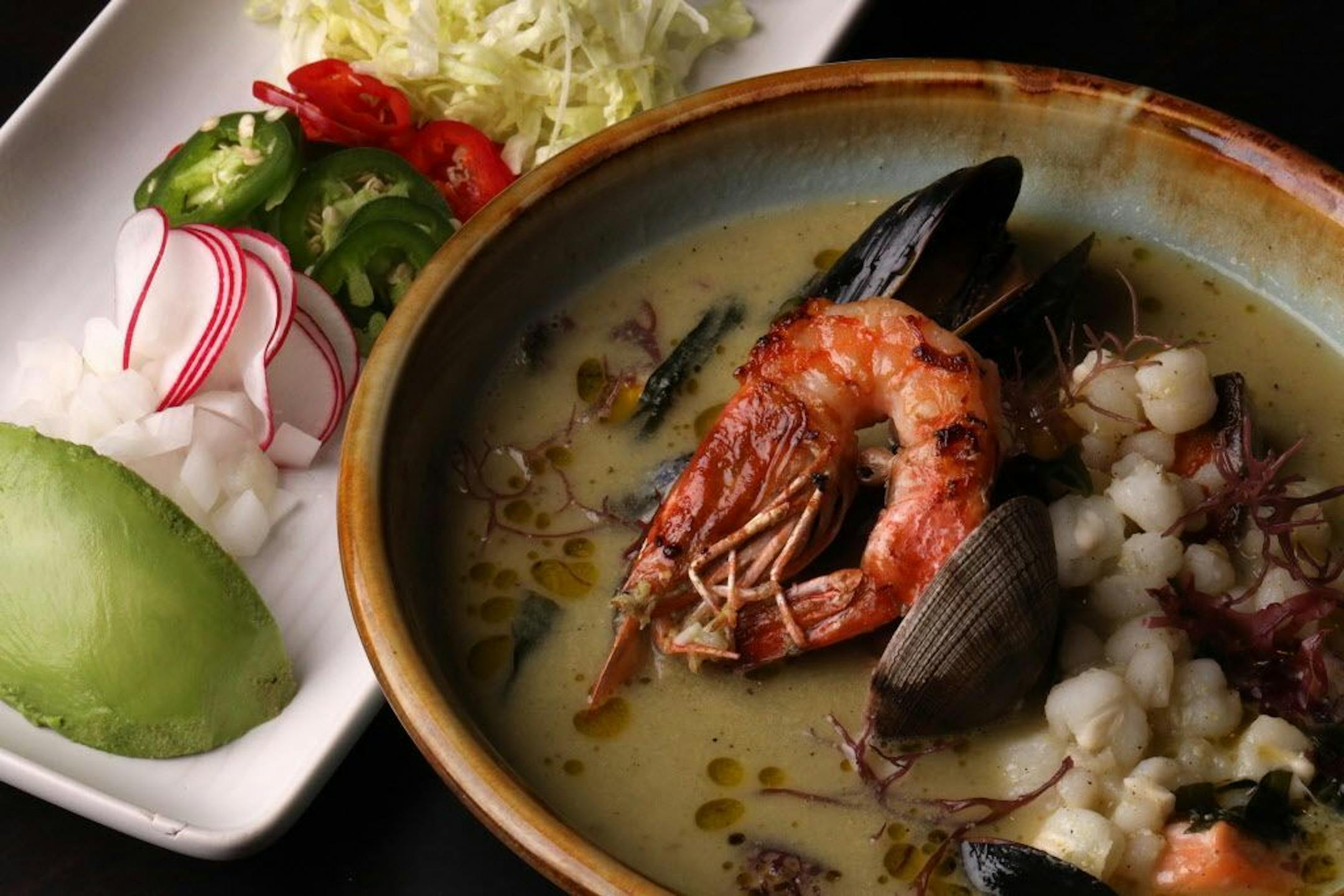 Pictured is the seafood pozole verde with hominy, jalapeno, and radish.