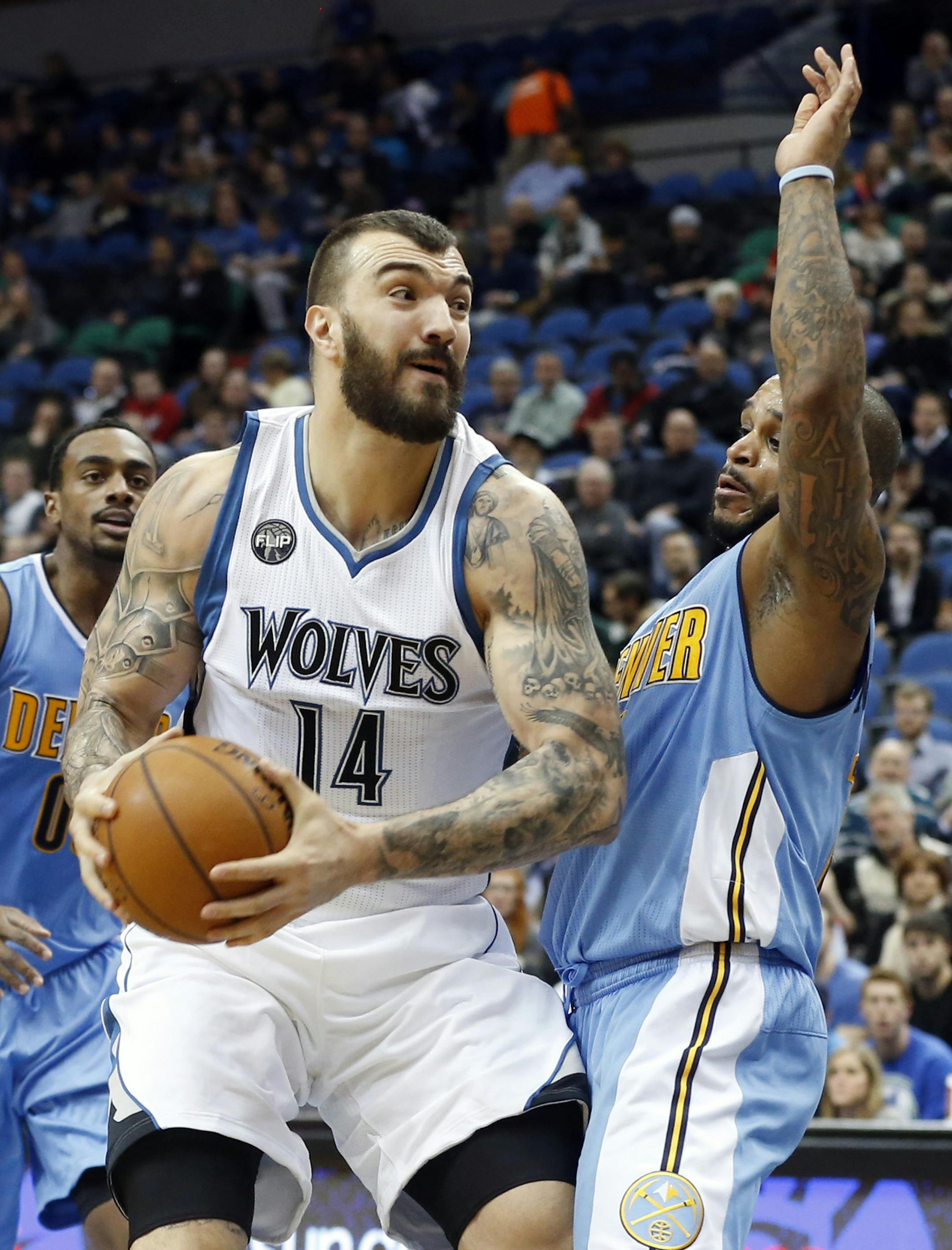 Minnesota Timberwolves&#x2019; Nikola Pekovic, left, of Montenegro, returned to the lineup following recovery an injury as Denver Nuggets guard Jameer Nelson defends in the first quarter of an NBA basketball game, Wednesday, Jan. 6, 2016, in Minneapolis. (AP Photo/Jim Mone)