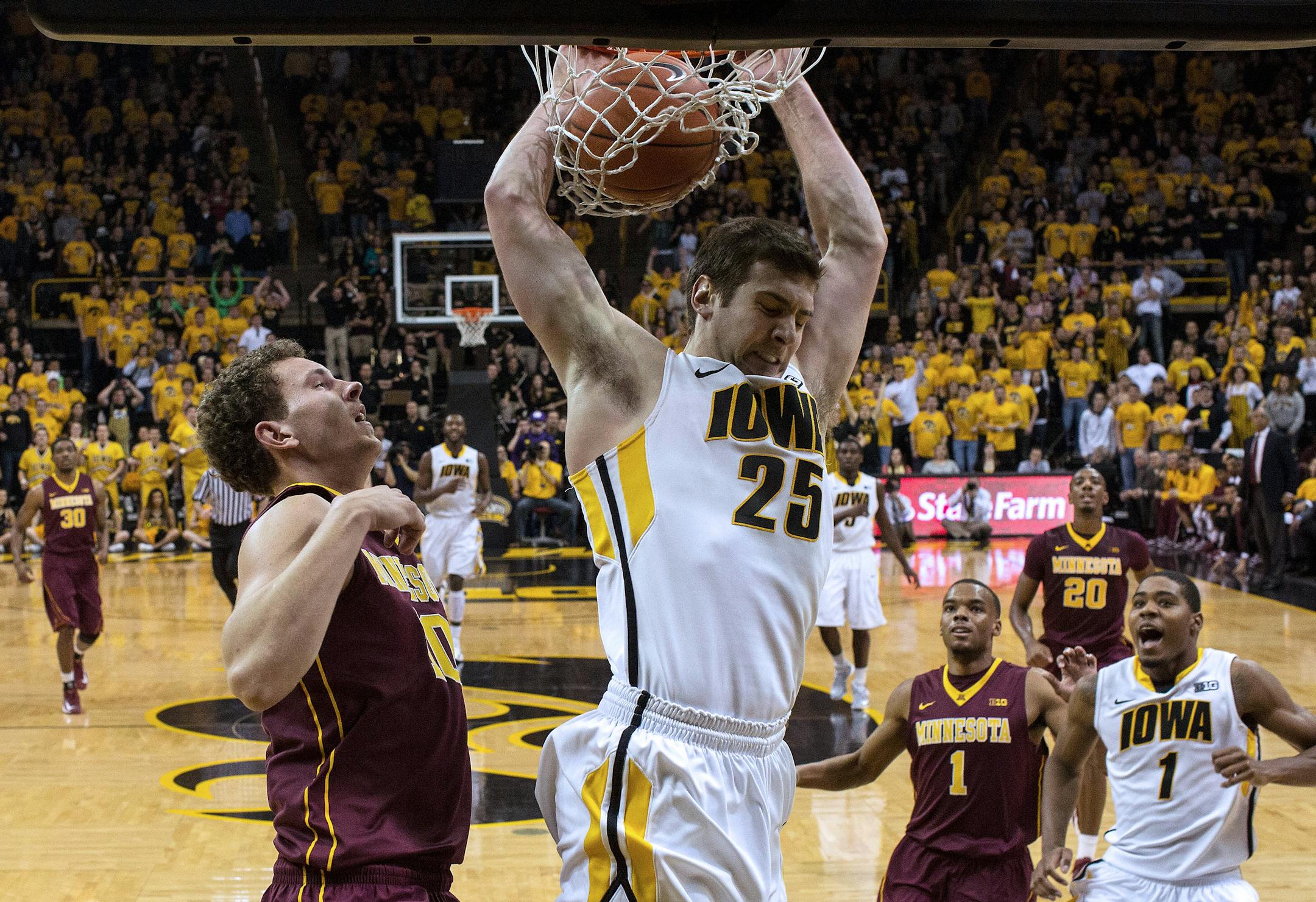 Iowa's Eric May did not find Oto Osenieks to be much of an impediment as the senior dunked Sunday. May had 10 points and seven rebounds off the bench.