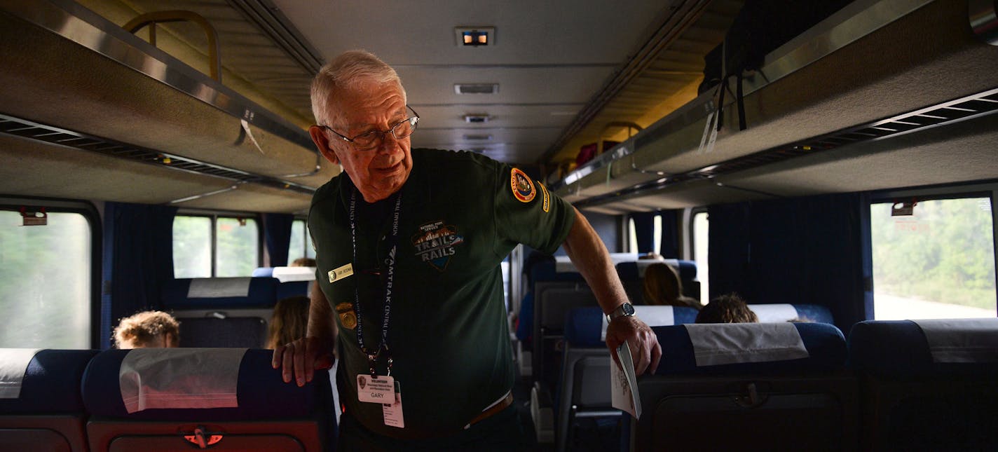 Volunteer Master Ranger Corps Gary Freseman walked through train cars looking for children who could complete the Junior Ranger Activity Booklet as part of the Trails and Rails program on the Amtrak Train that departed from Union Depot in St. Paul, Minn. and went to Chicago, Illinois, on Monday July 27, 2015. ] RACHEL WOOLF &#xb7; rachel.woolf@startribune.com