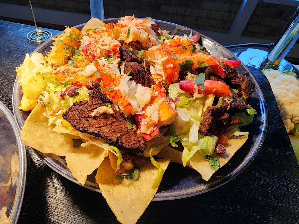 Surf & Turf Nachos — house-fried tortilla chips with blackened sirloin, lobster queso, diced jalapenos, lettuce and tomatoes — are available in the general concessions area during the first two Timberwolves playoff games.