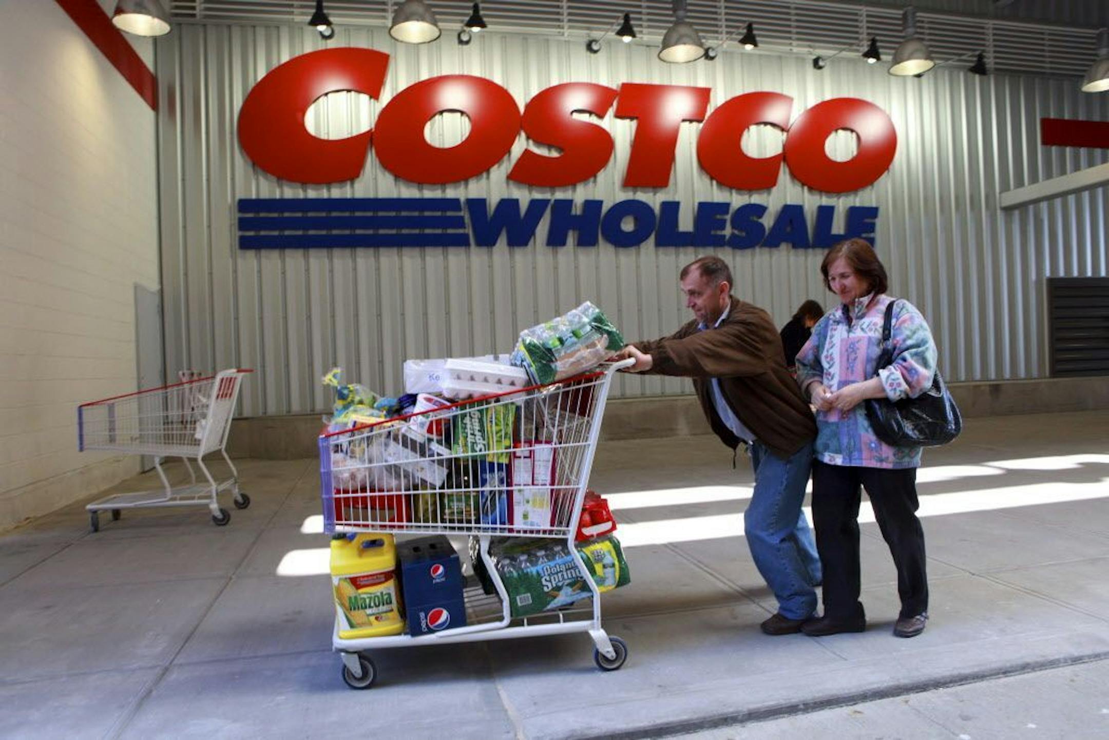 Shoppers leave Costco in New York on April 30, 2010. April retail sales were not as strong as March, but big chains reported better sales than last year.