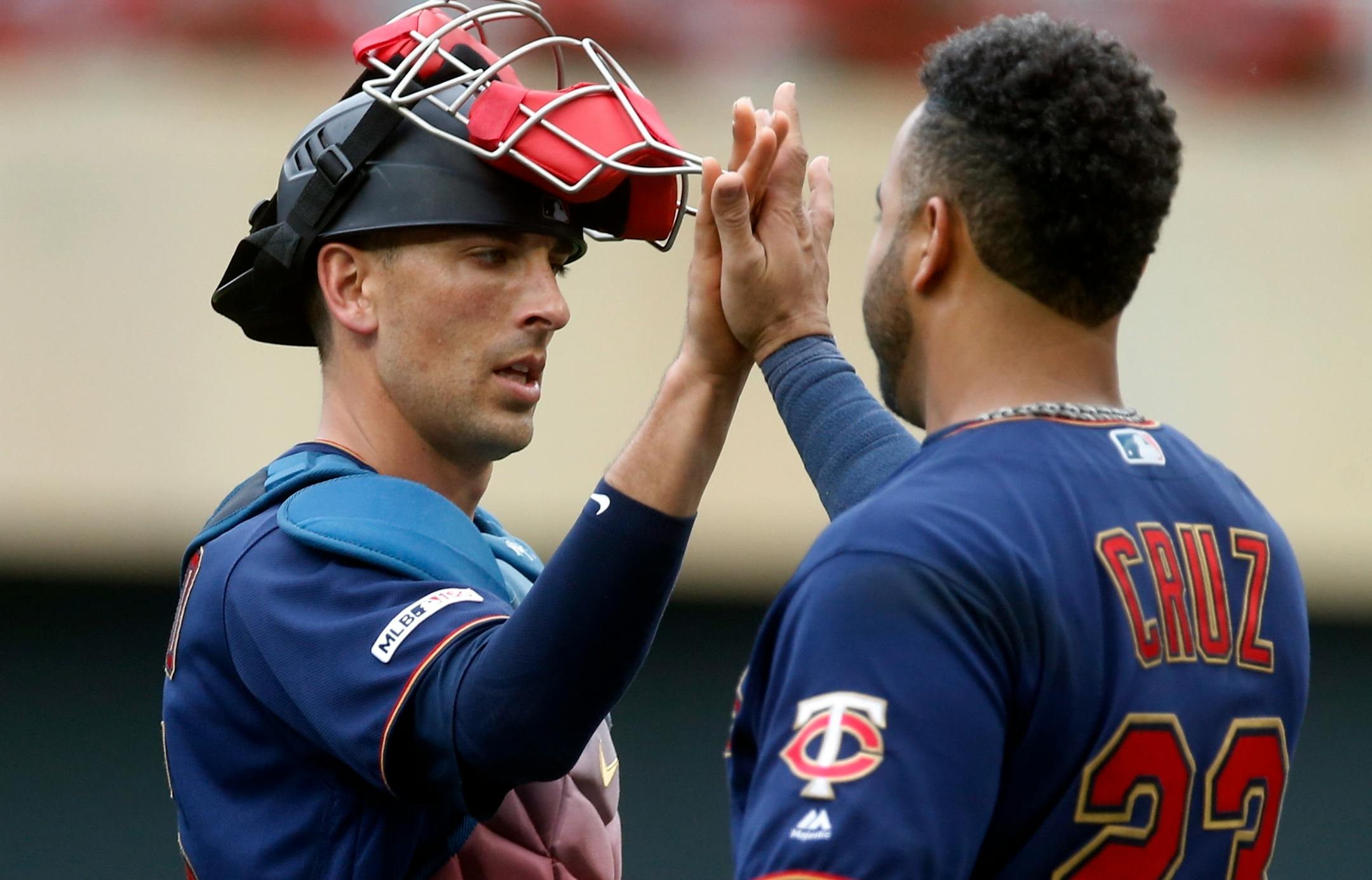 Minnesota Twins' Jason Castro, left, and Nelson Cruz high-five after they defeated the Texas Rangers in a baseball game Saturday, July 6, 2019, in Minneapolis. (AP Photo/Jim Mone)