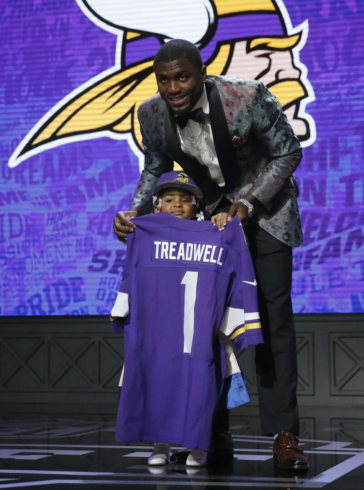 Mississippi&#xed;s Laquon Treadwell poses for photos with his daughter Madison after being selected by the Minnesota Vikings as the 23rd pick in the first round of the 2016 NFL football draft, Thursday, April 28, 2016, in Chicago. (AP Photo/Charles Rex Arbogast) ORG XMIT: ILKS221