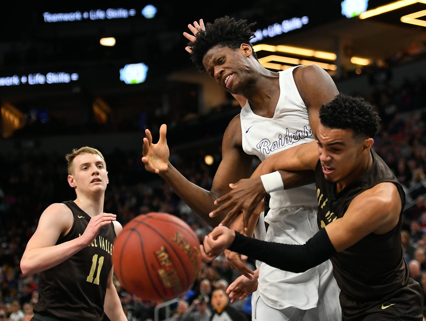 Apple Valley guard Tre Jones (3) knocked the ball loose from Cretin-Derham Hall forward Daniel Oturu (25) during the 2018 state basketball tournament. Both were draft on Wednesday night.