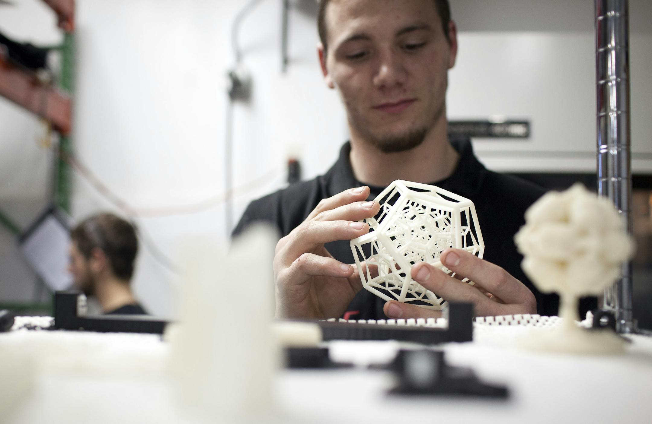 Machinist Matthew Doom looks at a 3D object at the Baklund R&D LLC shop in Hutchinson, Minnesota, U.S., on Wednesday, Nov. 6, 2013. Baklund, which hired four people in the last year and is seeking two more, is one of hundreds of small shops across the U.S. leveraging technology to meet demand for low volume, highly-customizable products. Photographer: Ariana Lindquist/Bloomberg *** Local Caption *** Matthew Doom ORG XMIT: 187406069