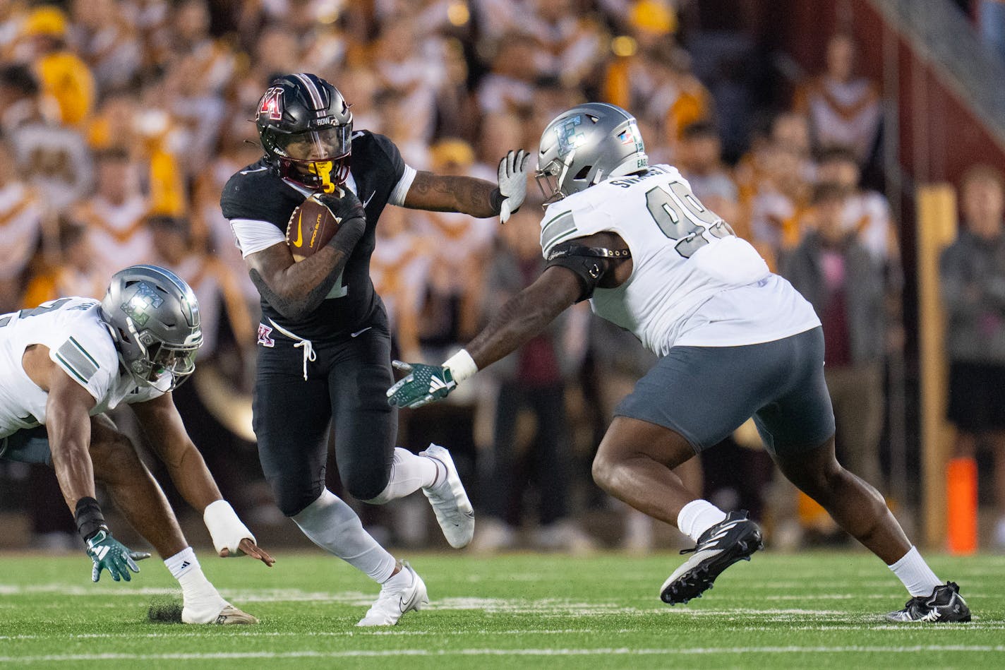 Minnesota running back Darius Taylor (1) stiff arms Eastern Michigan defensive lineman Melvin Swindle II (99) in the second quarter Saturday, Sep. 09, 2023, at Huntington Bank Stadium in Minneapolis, Minn. ]