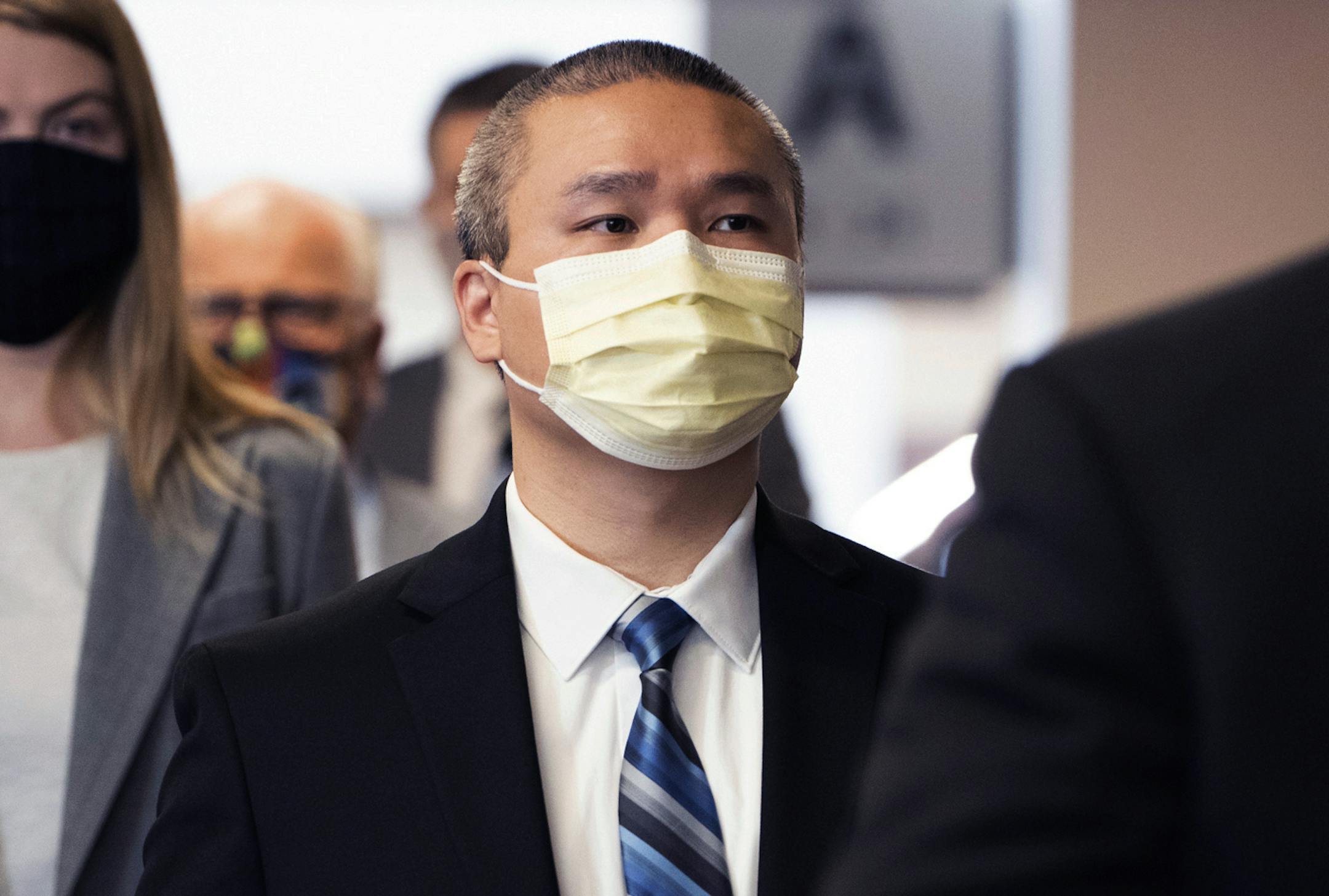 In this July 21, 2020 photo, former Minneapolis police officer Tou Thao is flanked by his attorneys as he arrives at the Hennepin County Courthouse before a motions hearing in Minneapolis.