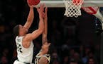 Michigan State guard Miles Bridges puts up a shot over Michigan guard Charles Matthews during the second half of a Big Ten Conference tournament semif