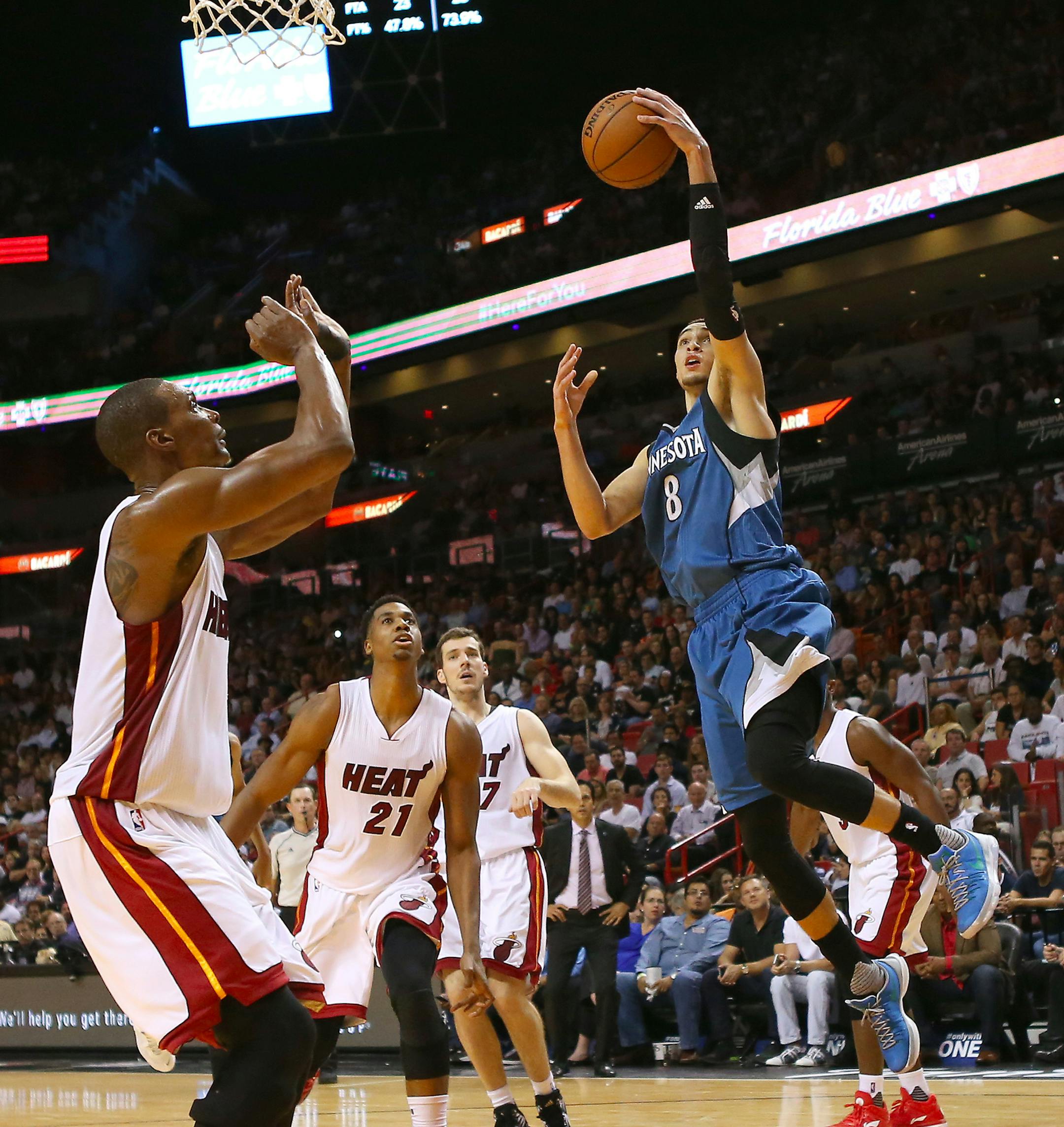 The Minnesota Timberwolves' Zach LaVine, right, drives to the basket against the Miami Heat's Chris Bosh during the fourth quarter at the AmericanAirlines Arena in Miami on Tuesday, Nov. 17, 2015. The Timberwolves won, 103-91. (David Santiago/El Nuevo Herald/TNS)