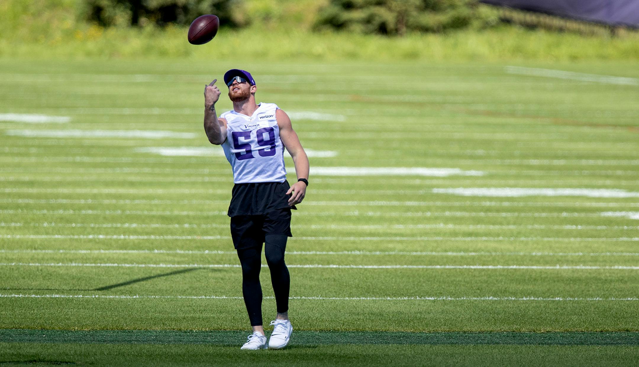 Minnesota Vikings LB Cam Smith (59) tossed a ball in the air.