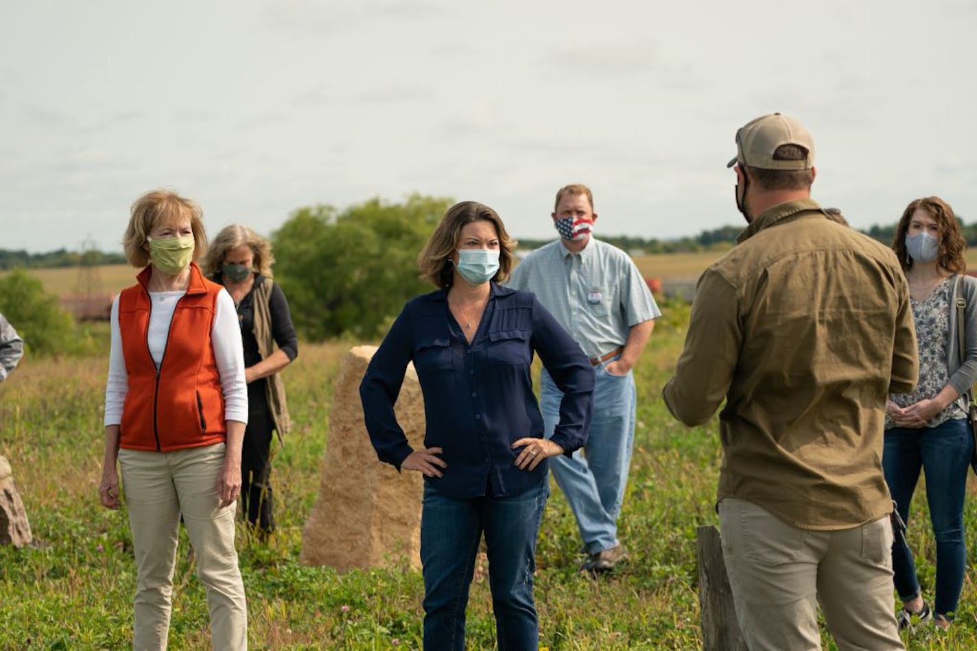 Rep. Angie Craig, center, and Sen. Tina Smith, left, visited the Main Street Project Farm in Northfield, Minnesota. They listened as farm co-manager Waytt Parks talked about the farm's mission.