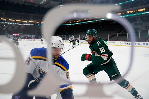 Minnesota Wild left wing Jordan Greenway (18) and St. Louis Blues defenseman Marco Scandella (6) battled during the first period.