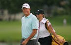 Tom Lehman smiled at cheering fans after teeing off at the first hole as his caddy carried his University of Minnesota golf bag behind him.