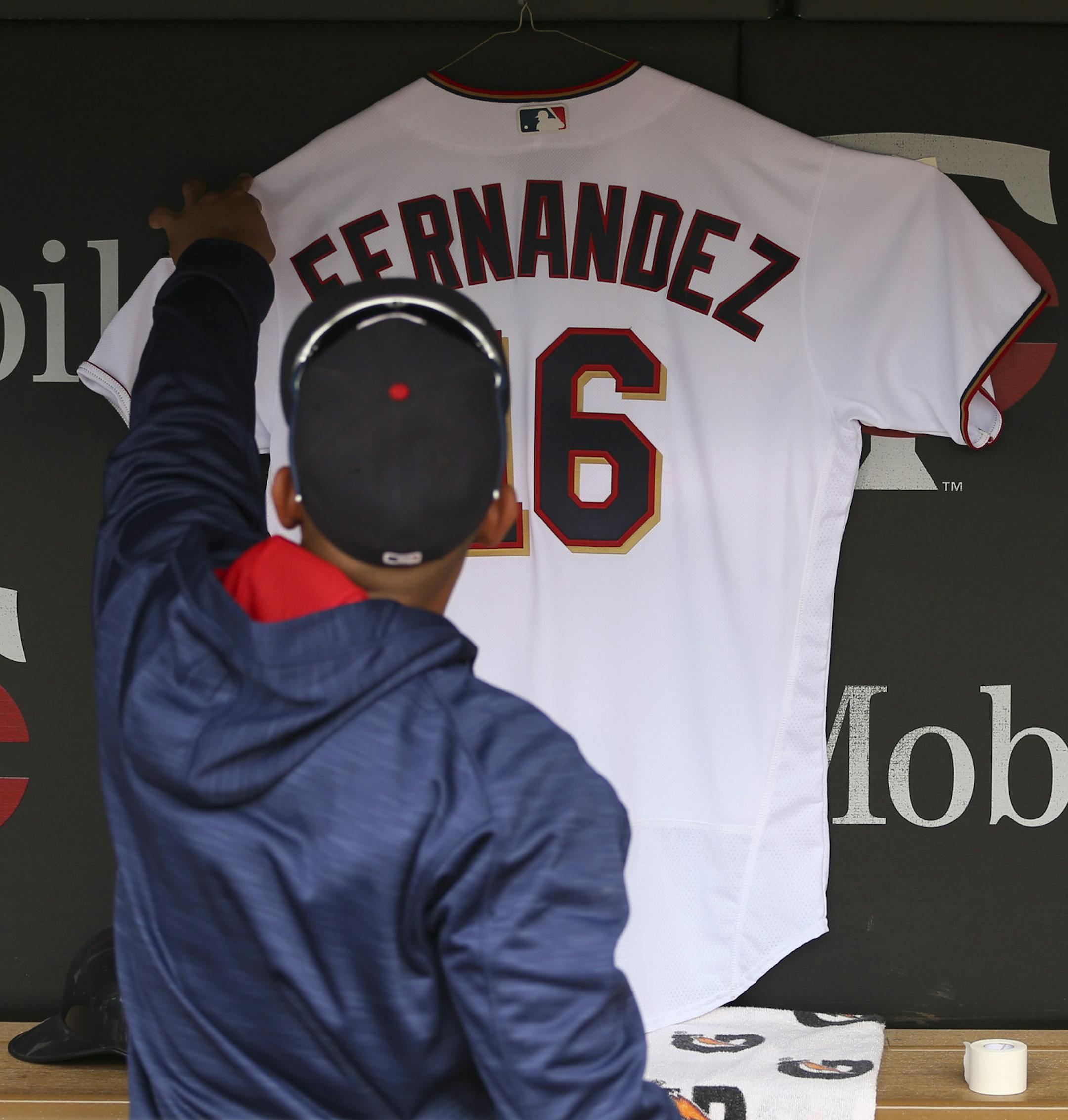 The Twins' Eduardo Escobar tidied the honorary jersey of Jose Fernandez, the Florida Marlins pitcher who died in a boating accident last night. ] JEFF WHEELER ï jeff.wheeler@startribune.com The Minnesota Twins faced the Seattle Mariners in the their final game of their series Sunday afternoon, September 25, 2016 at Target Field in Minneapolis.