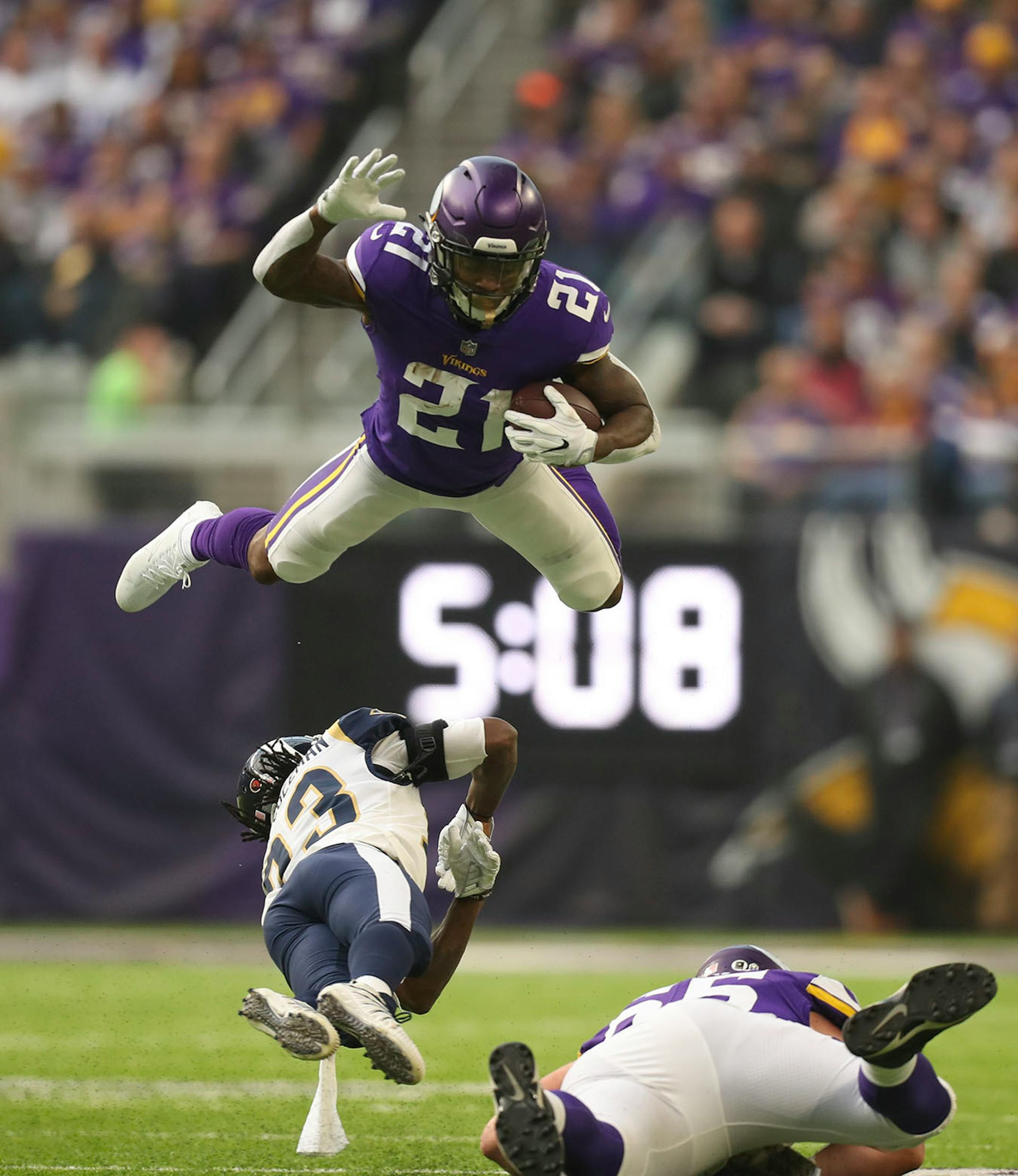 Minnesota Vikings running back Jerick McKinnon went high when Los Angeles Rams cornerback Nickell Robey-Coleman (23) went low on a tackle after McKinnon gained 15 yards on a short pass in the firs quarter.