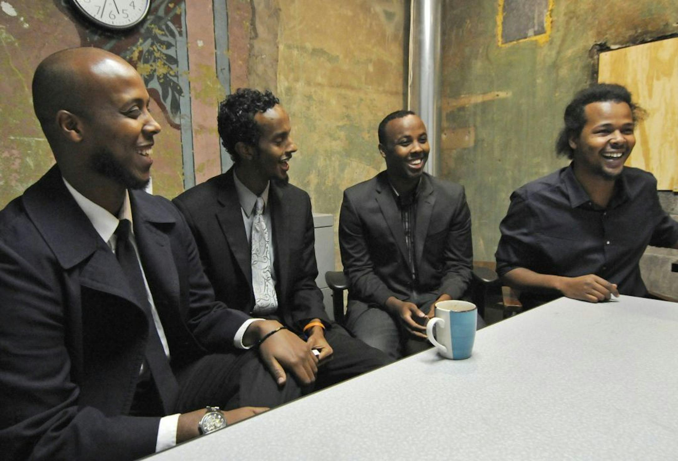 A group of college-age Somalis, from left, Abdifatah Farah, Abdimalik Mohamed, Mohamed Farah and Abdul Mohamed, enjoy a laugh during an interview Tuesday, Oct. 23, 2012 in Minneapolis, are part of a grassroots group called Ka Joog which teaches Somali youth about the value of higher education, self-expression through the arts and self-empowerment. The group is being recognized by the FBI for its work.