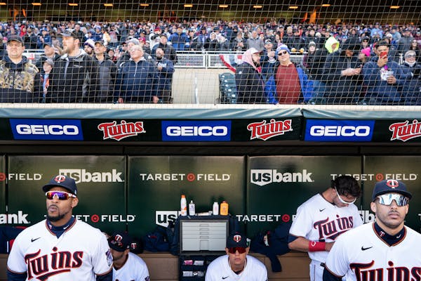 Minnesota Twins center fielder Byron Buxton , (25) left and shortstop Carlos Correa ,(4) stood in the dugout at Target Field during pregame in Minneap