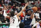 Minnesota Timberwolves guard Jaylen Nowell, right, looks to shoot against the defense of Portland Trail Blazers forward Trendon Watford, left, during 