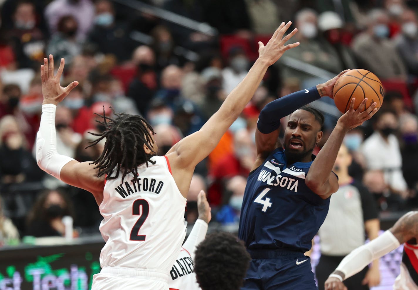 Minnesota Timberwolves guard Jaylen Nowell, right, looks to shoot against the defense of Portland Trail Blazers forward Trendon Watford, left, during the second half of an NBA basketball game in Portland, Ore., Sunday, Dec. 12, 2021. Minnesota defeated Portland 116-111. (AP Photo/Steve Dipaola)