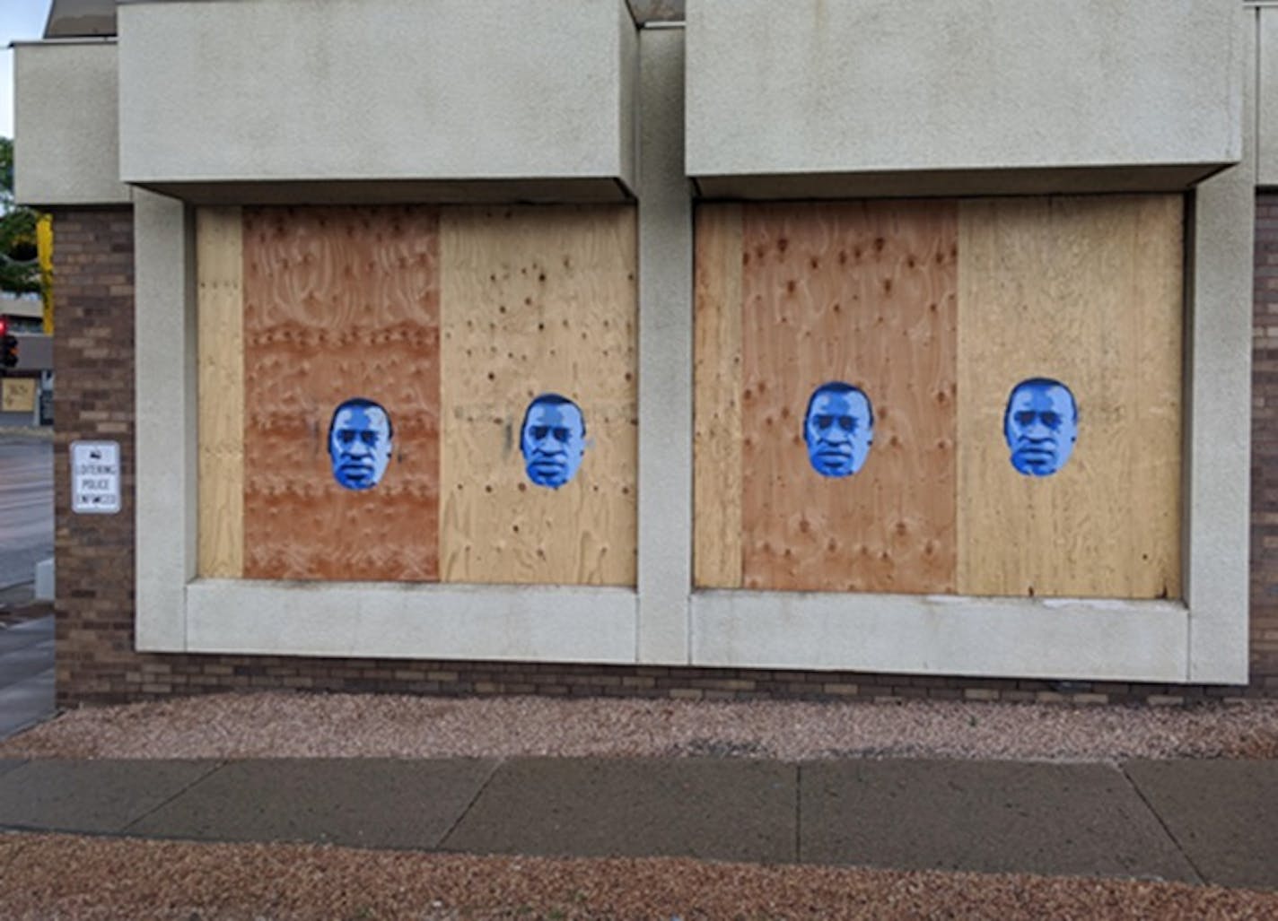 Artwork of George Floyd, made from a free stencil, on a boarded-up U.S. Bank branch on Lake Street across from the Midtown Global Market.