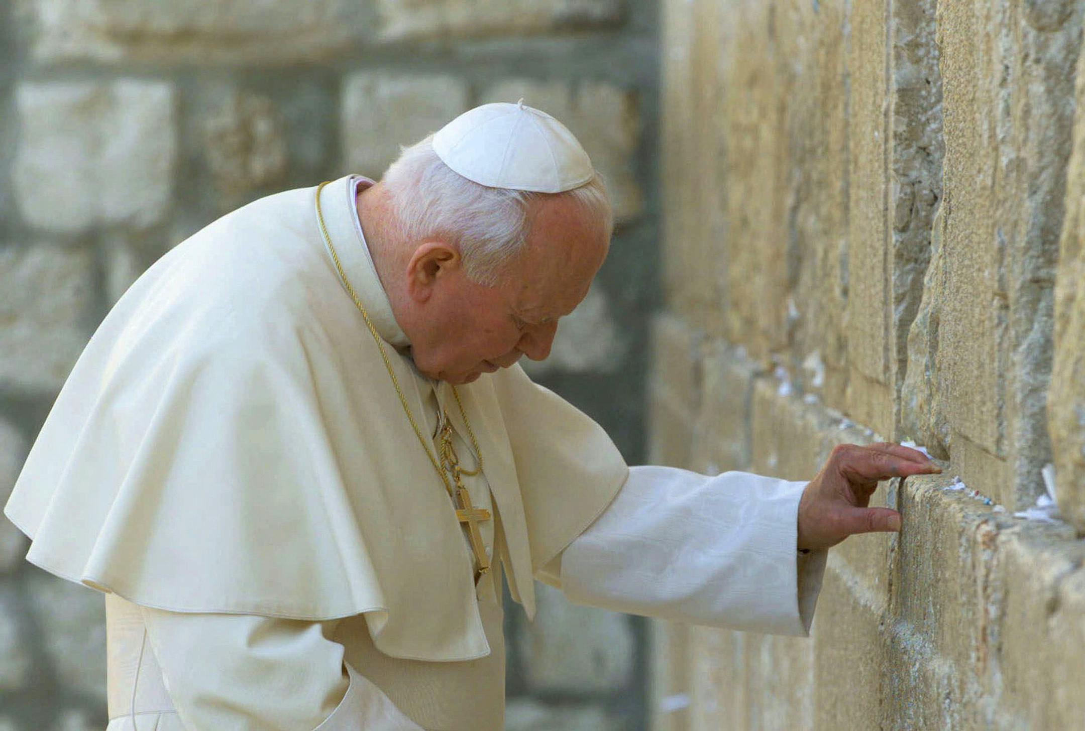 ** ADVANCE FOR FRIDAY AMS, MAY 28--FILE **Pope John Paul II rests his hand on the Western Wall in the Old City of Jerusalem, in this March 26, 2000 file photo. (AP Photo/Jerome Delay/FILE) ORG XMIT: MIN2017012018010728