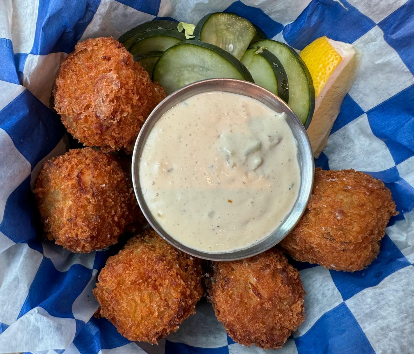 Giant walleye tots with tarter sauce and a lemon wedge at Farmers Kitchen + Bar in Minneapolis' Mill District.