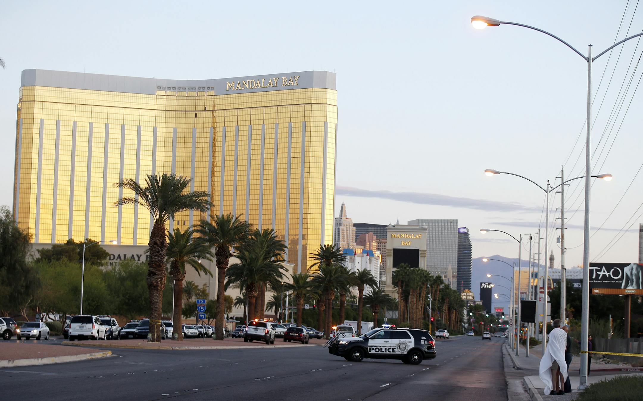 Police along the Las Vegas strip the morning of Oct. 2, 2017, hours after a gunman at the nearby Mandalay Bay Resort and Casino rained a rapid-fire barrage on an outdoor concert nearby. The gunman – identified as 64-year-old Stephen Paddock – killed at least 50 people, and wounded hundreds of others, officials said. (Isaac Brekken/The New York Times)